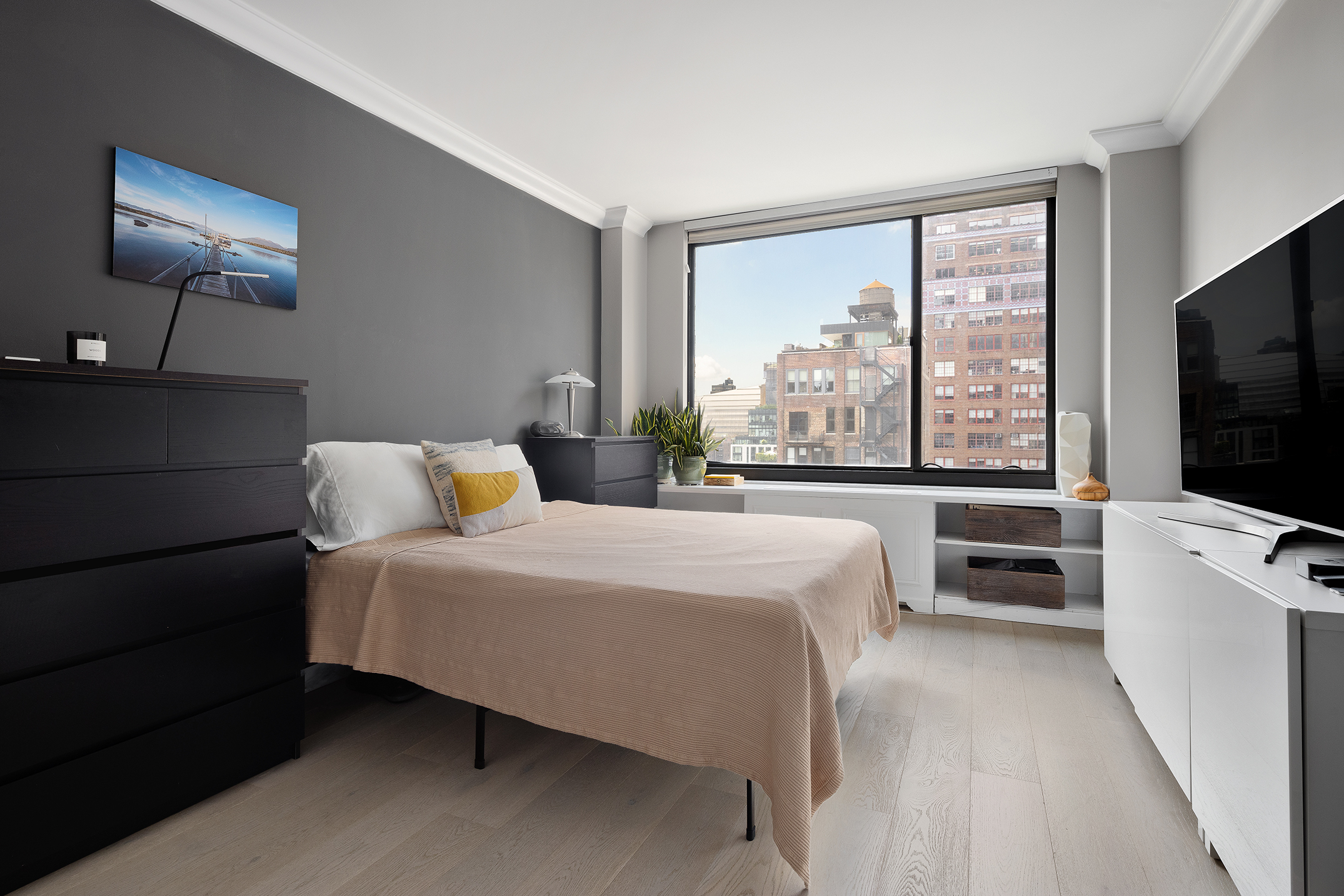 111 East 30th Street, Unit 16C Manhattan, NY 10016 - Photo 7 of 13 a bedroom with a bed and a flat tv screen on the dresser