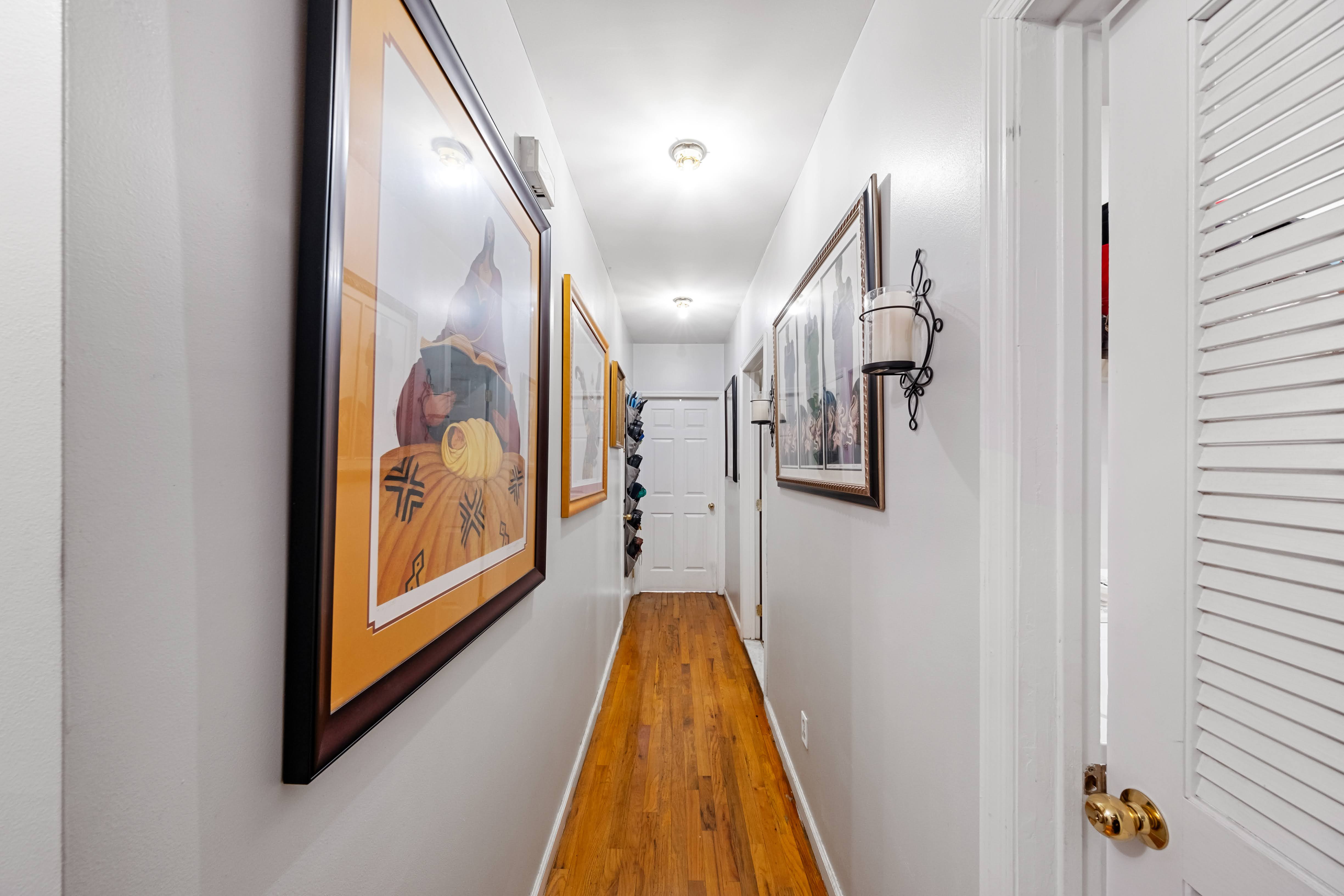 275 Van Buren Street Brooklyn, NY 11221 - Photo 10 of 33 a view of a hallway with wooden floor