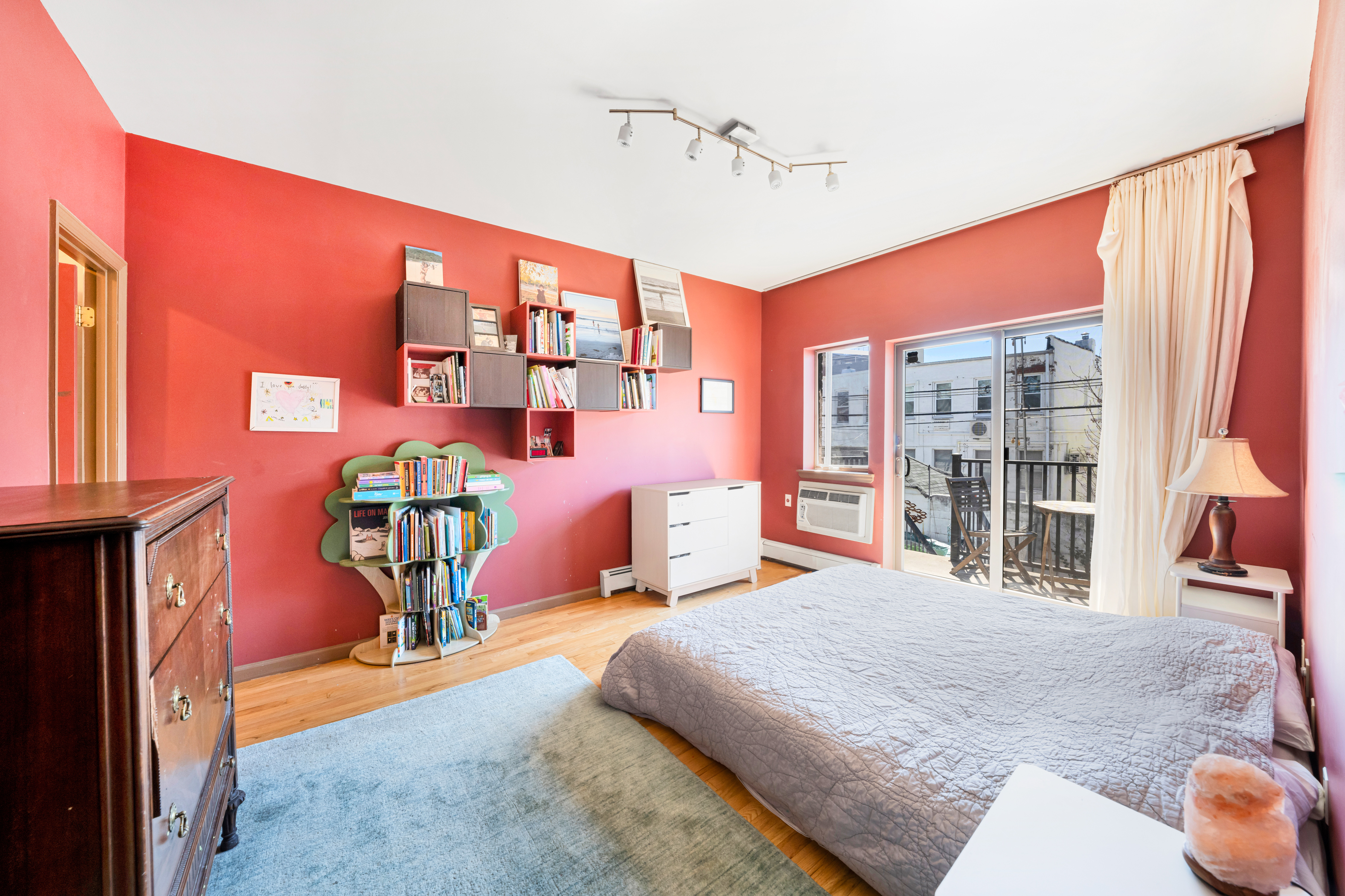 2356 61st Street, Unit 1B Brooklyn, NY 11204 - Photo 4 of 10 a bedroom with furniture and a large window