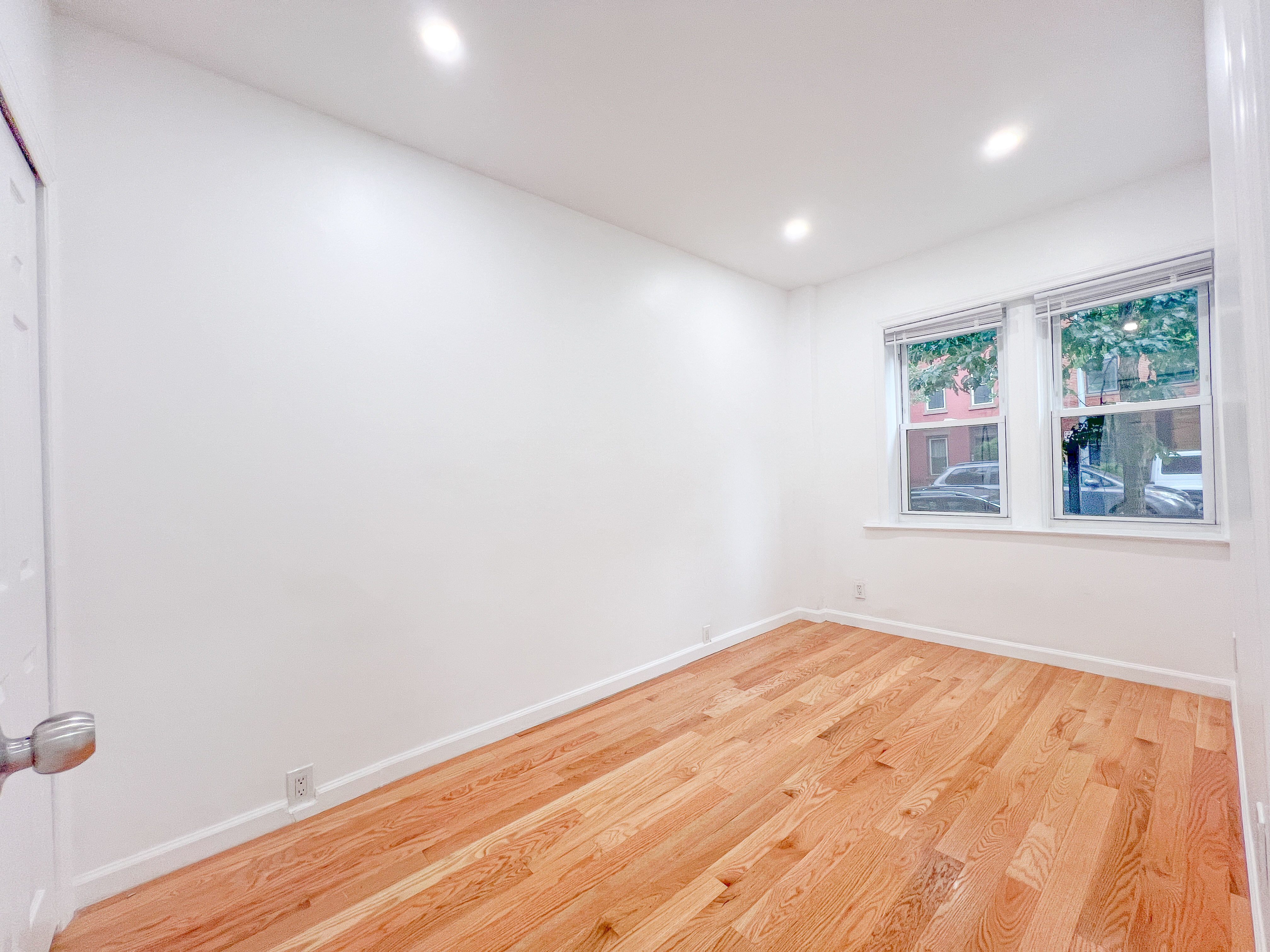 955 Pacific Street, Unit 1 Brooklyn, NY 11238 - Photo 5 of 12 a view of empty room with wooden floor and fan