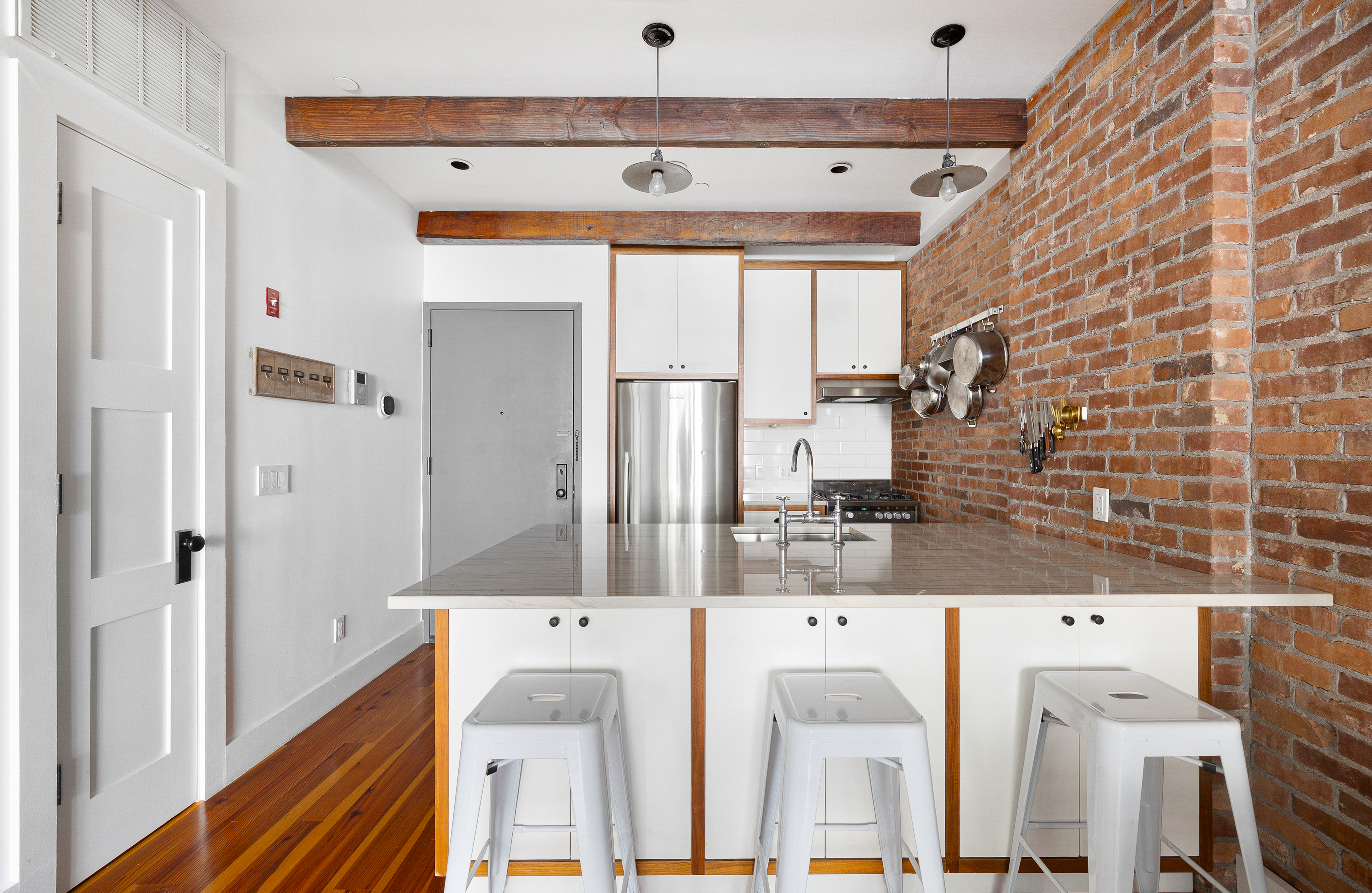 174 Jackson Street, Unit 2A Brooklyn, NY 11211 - Photo 5 of 17 a bathroom with a granite countertop sink and a mirror
