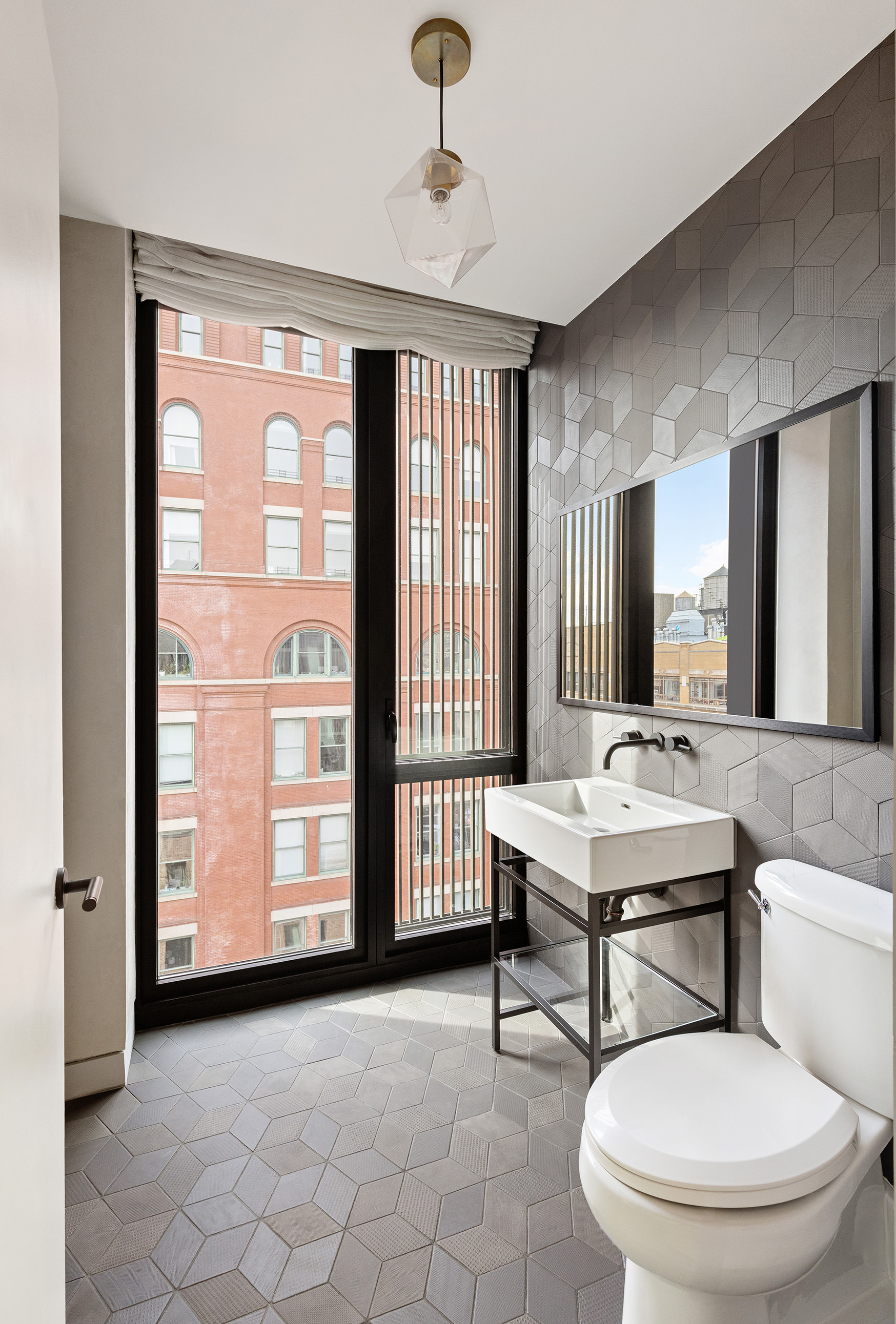 100 Barrow Street, Unit 11A Manhattan, NY 10014 - Photo 6 of 16 a bathroom with a toilet a sink and mirror