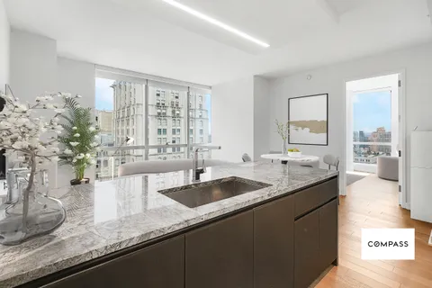 a kitchen with granite countertop a sink and a white stainless steel appliances
