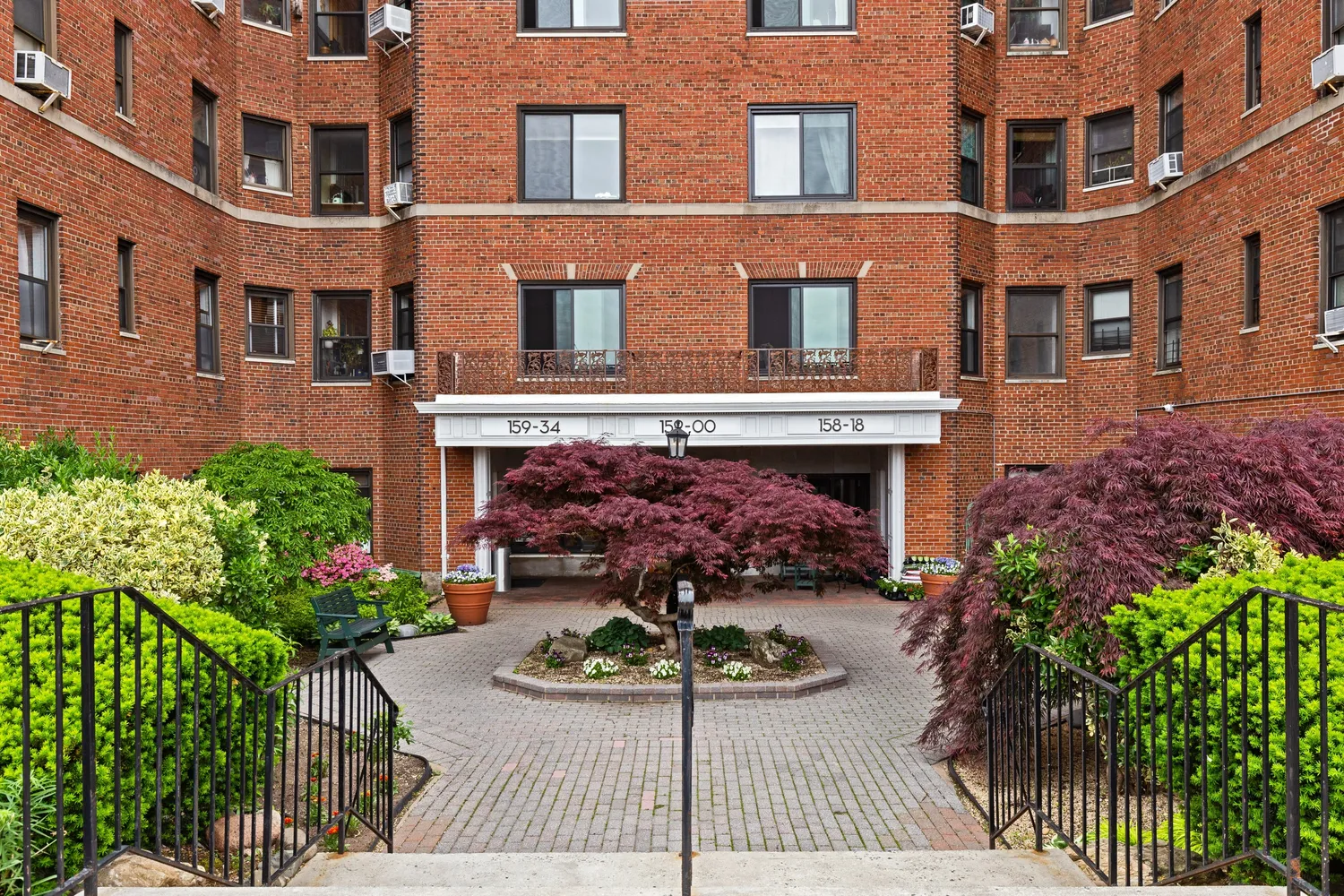 a front view of a building with potted plants