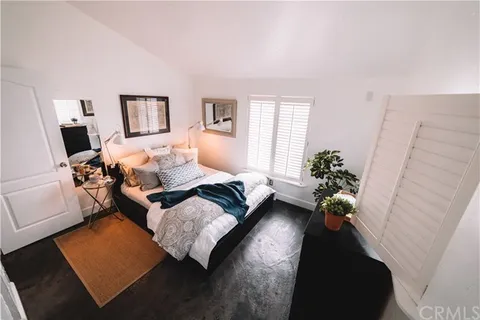 a bed room with a bed window and a couch
