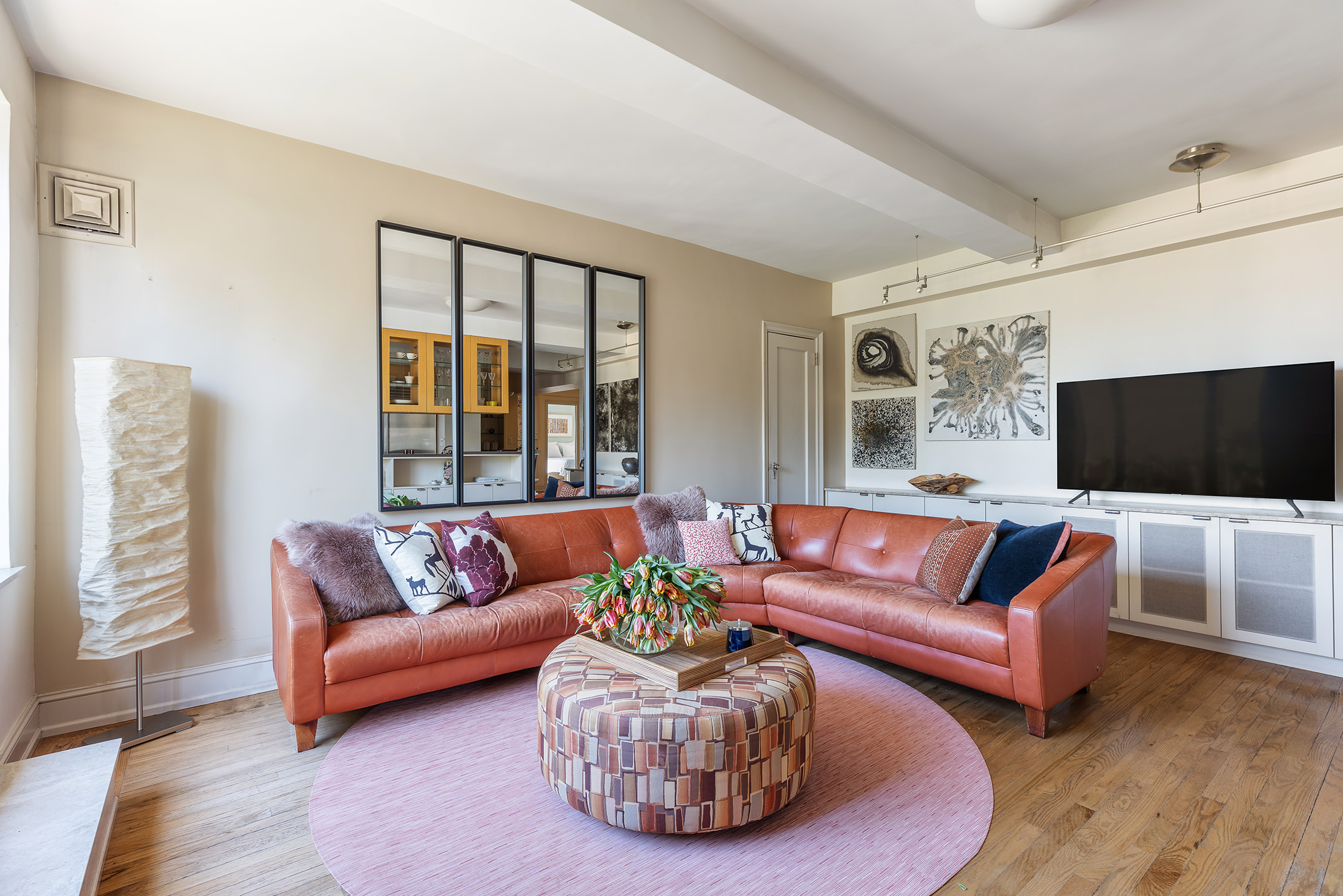 200 East 16th Street, Unit 19D Manhattan, NY 10003 - Photo 4 of 14 a living room with furniture and a flat screen tv