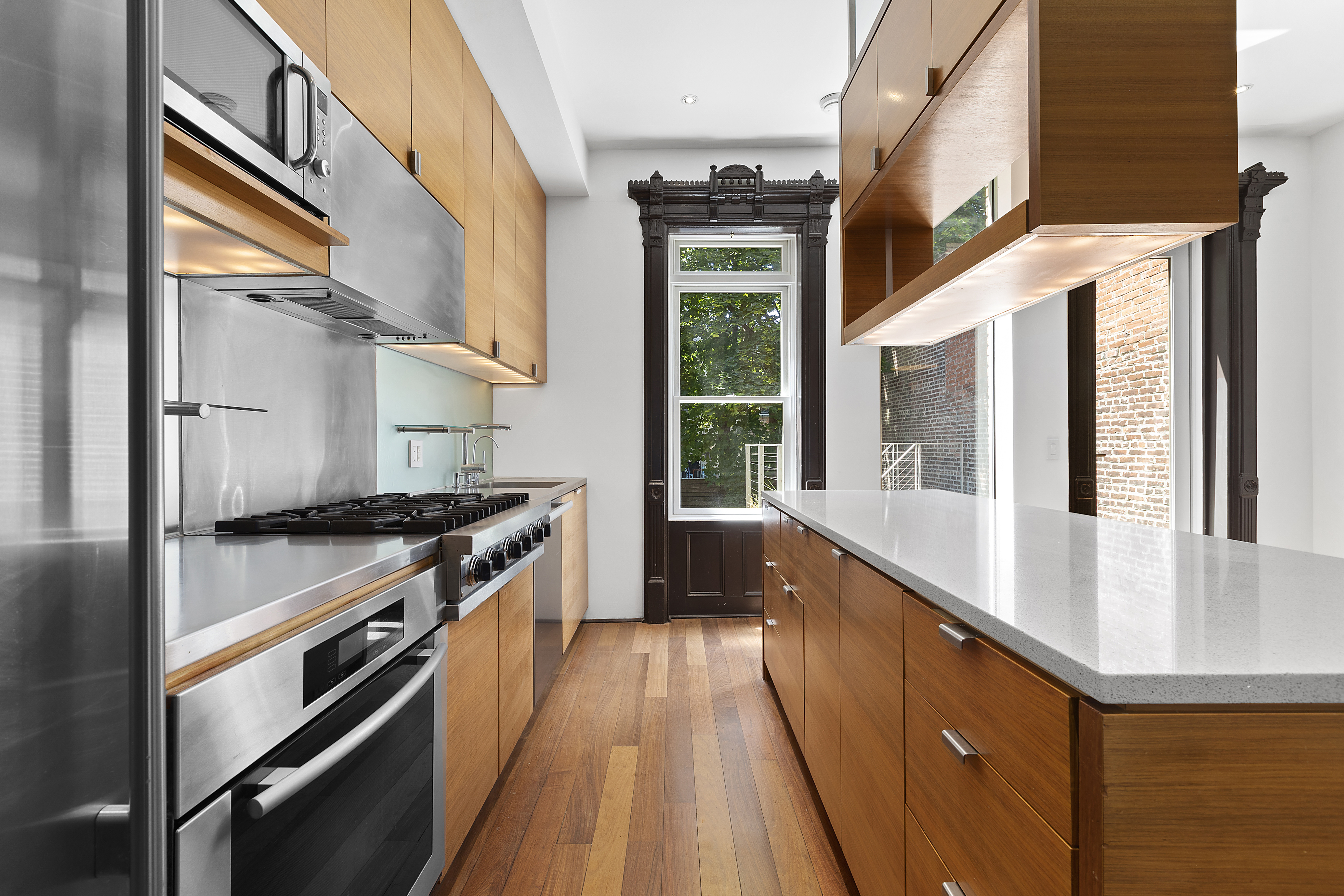 64 Clifton Place Brooklyn, NY 11238 - Photo 4 of 22 a kitchen with stainless steel appliances granite countertop a stove and a sink
