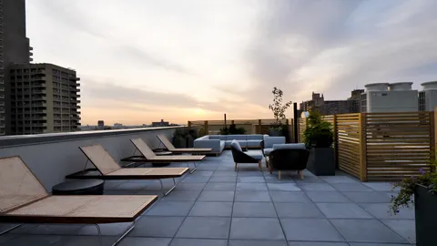 a terrace with outdoor seating and city view
