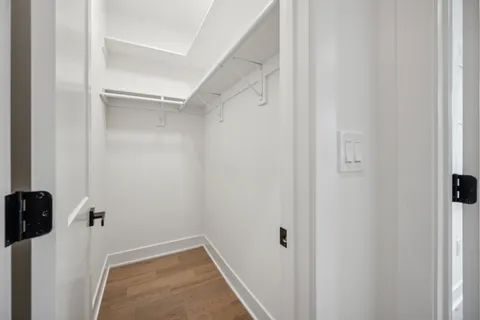 a bed sitting in a bedroom next to a window