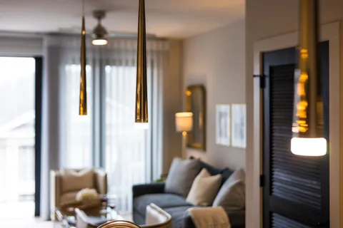 a view of a living room with a sink and chandelier