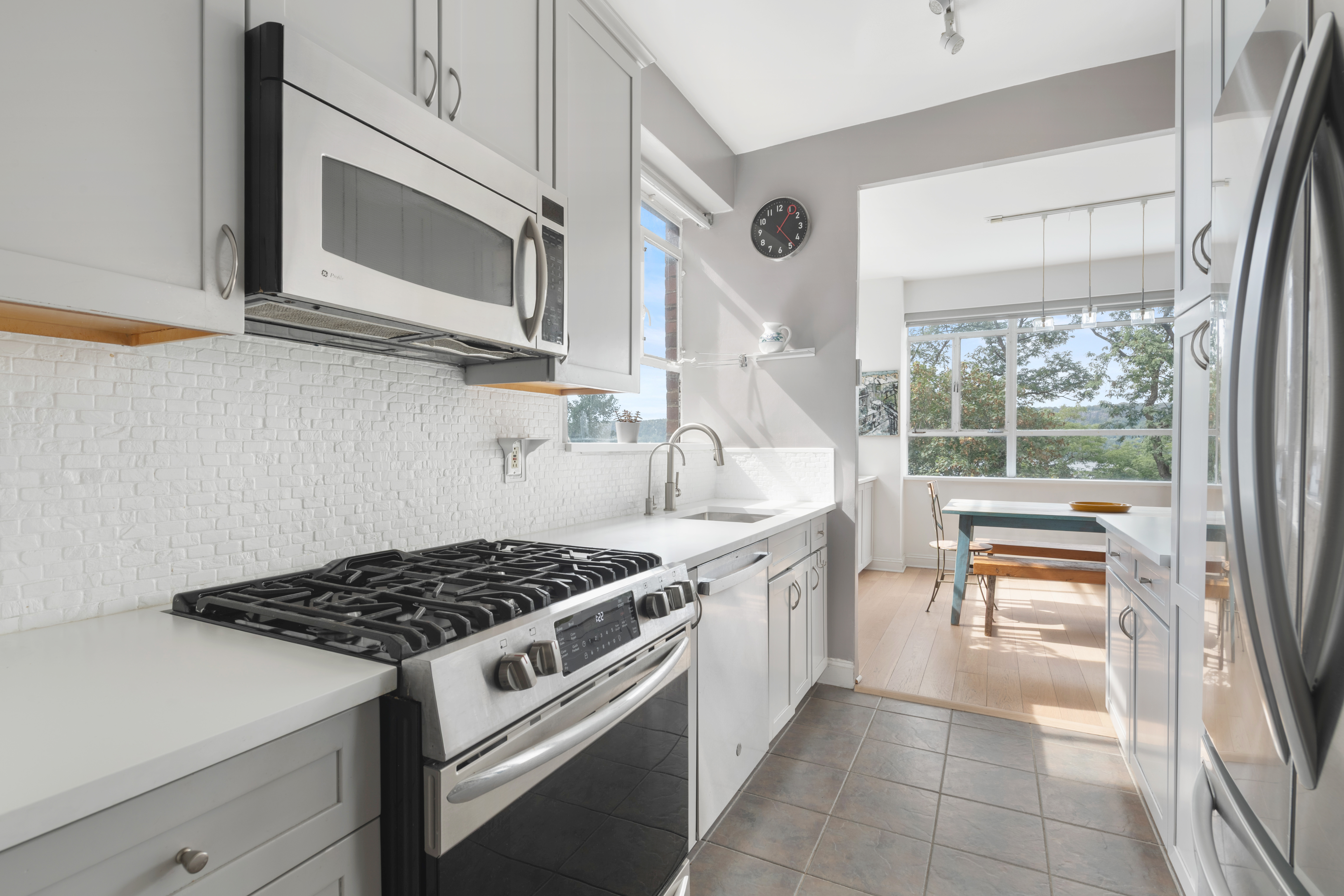 2727 Palisade Avenue, Unit 3H Bronx, NY 10463 - Photo 5 of 18 a kitchen with stainless steel appliances a stove a sink and a microwave