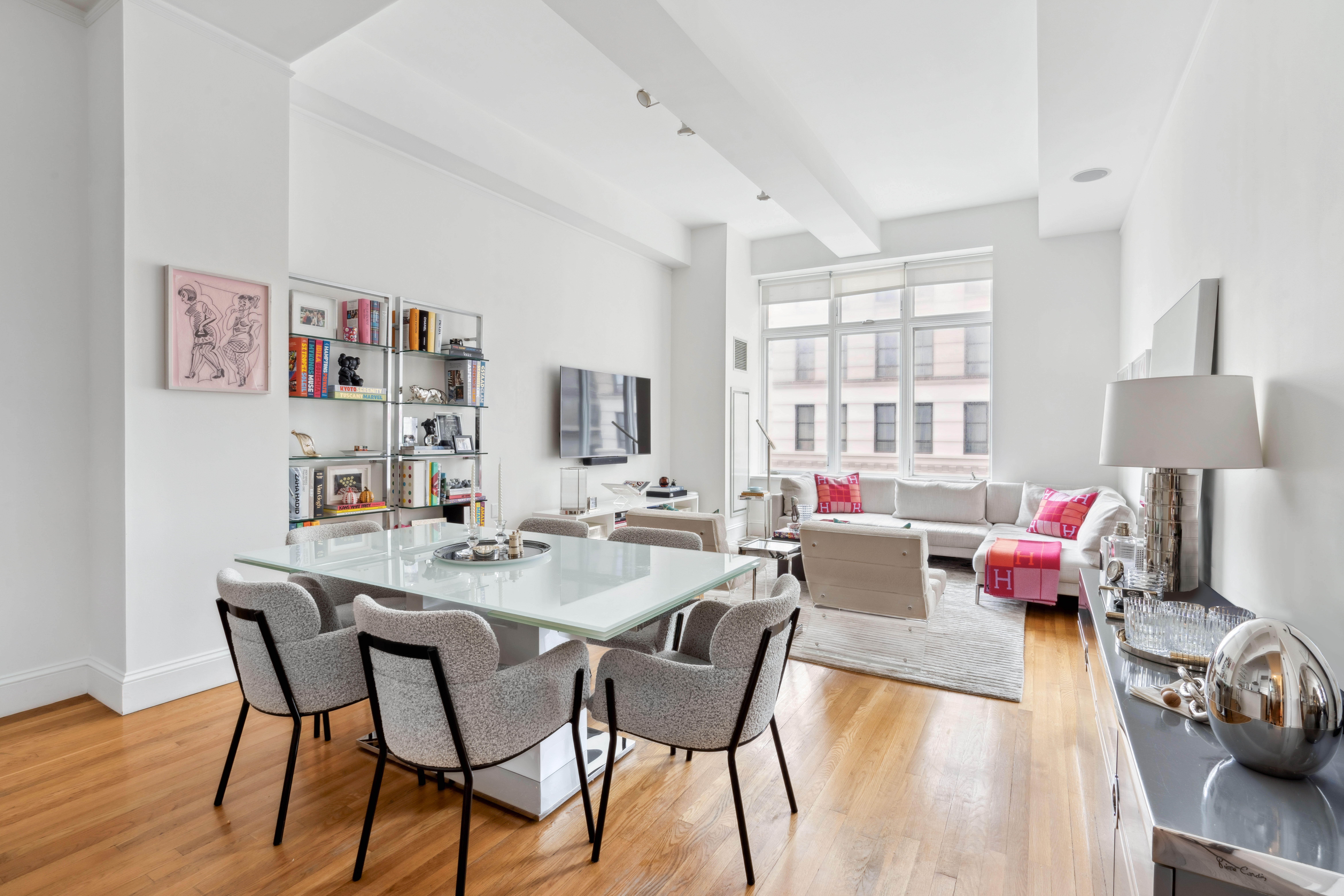 129 Lafayette Street, Unit 3B Manhattan, NY 10013 - Photo 3 of 13 a view of a dining room with furniture a rug and wooden floor