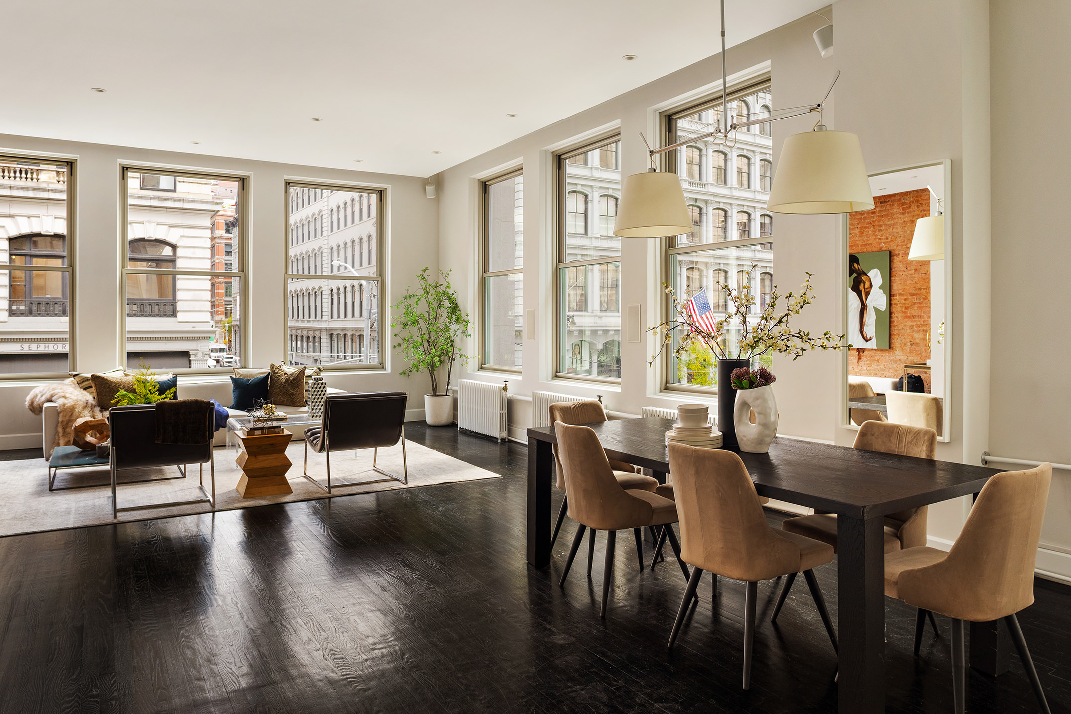 142 5th Avenue, Unit 2 Manhattan, NY 10011 - Photo 2 of 18 a living room with furniture and floor to ceiling windows