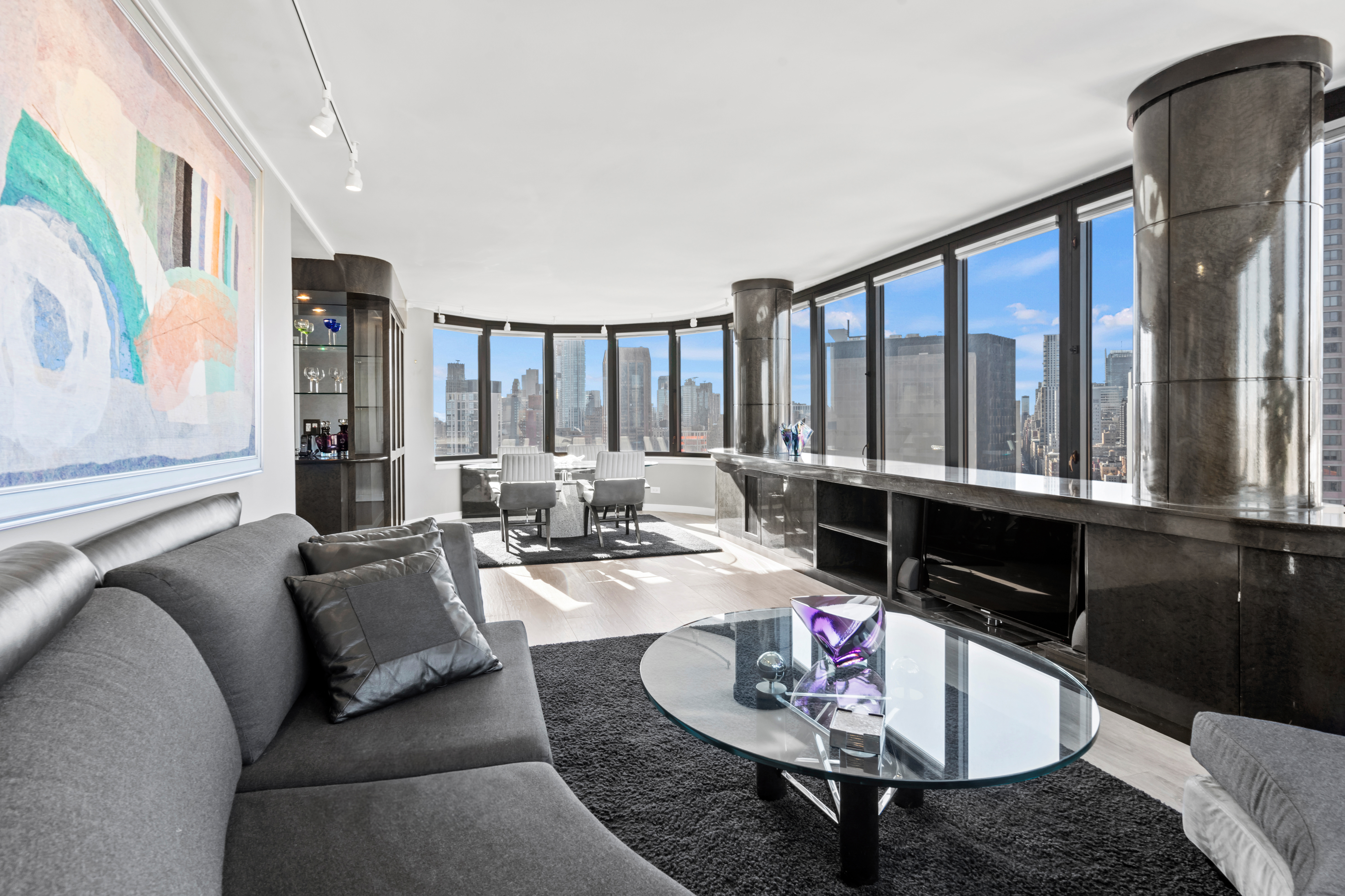 a living room with furniture and a floor to ceiling window