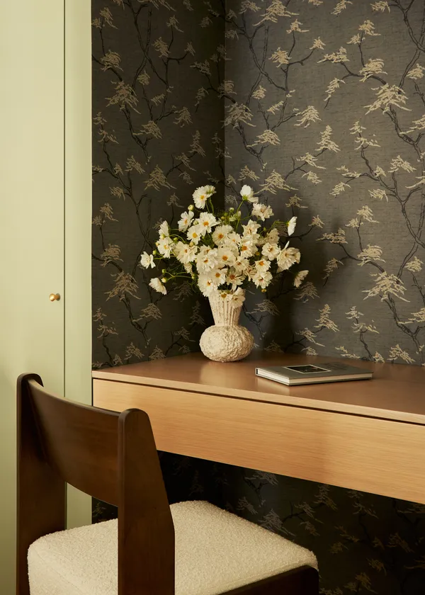a vase of flowers sitting on a dining table