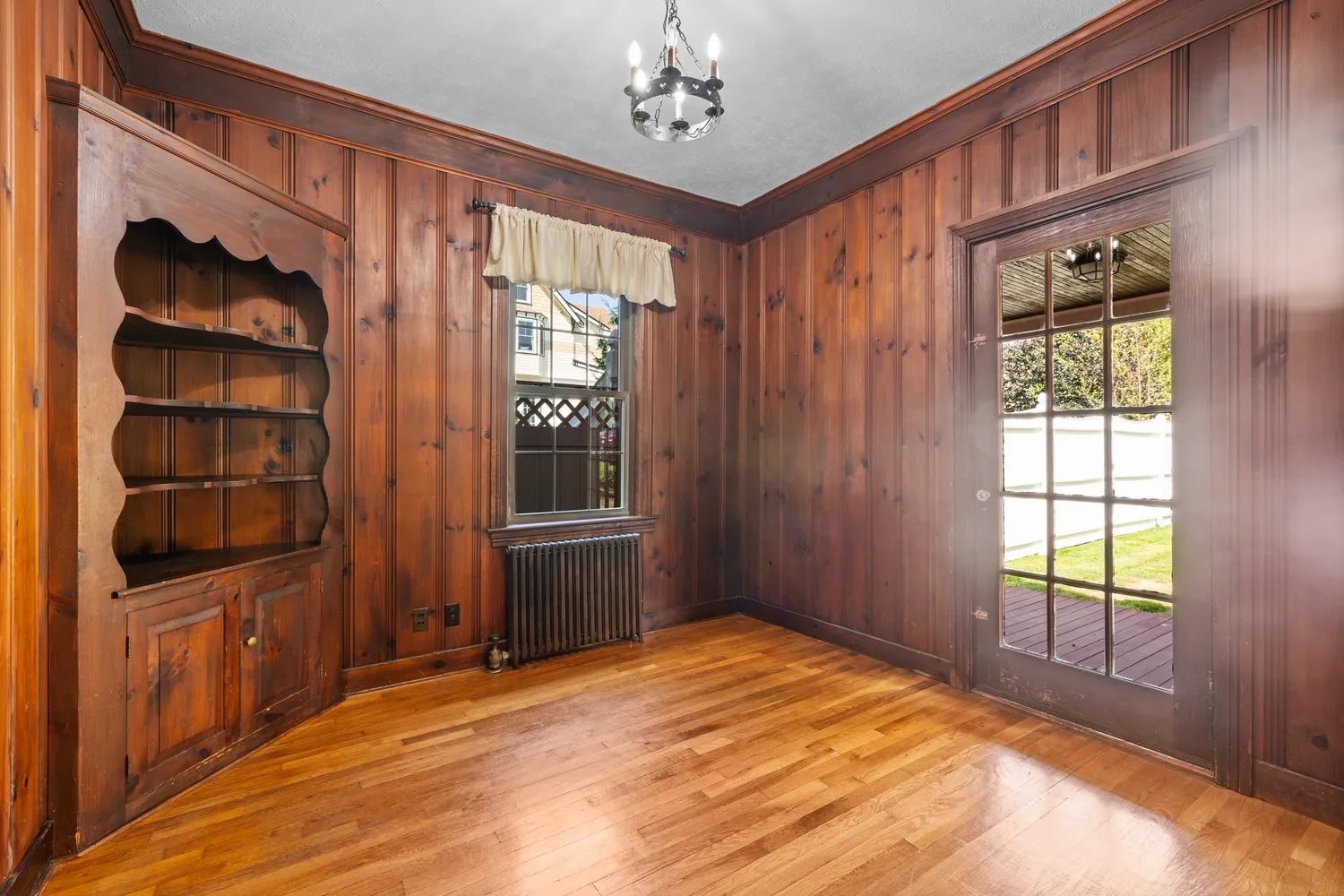 a view of an empty room with a window and closet