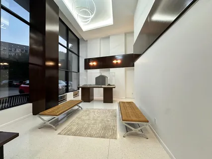 a living room with stainless steel appliances kitchen island granite countertop a sink and cabinets