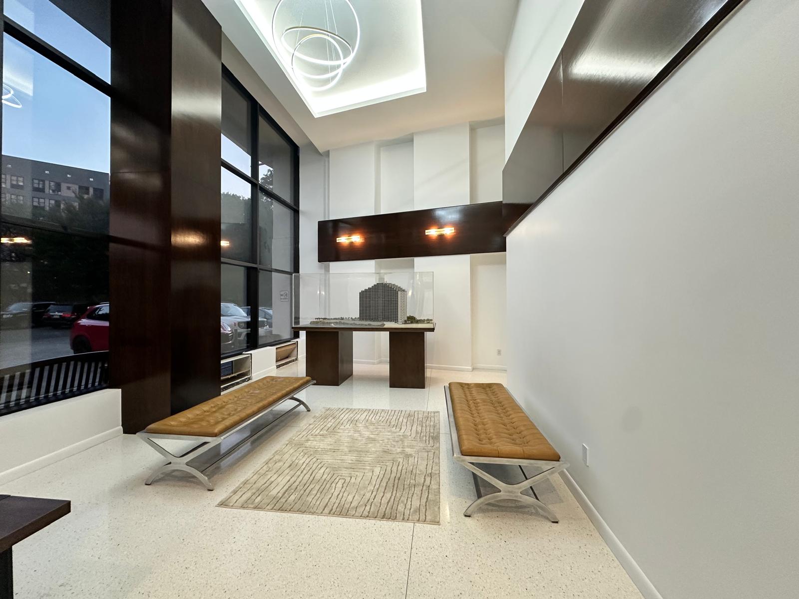25-40 Shore Boulevard, Unit 15T Queens, NY 11102 - Photo 15 of 24 a living room with stainless steel appliances kitchen island granite countertop a sink and cabinets