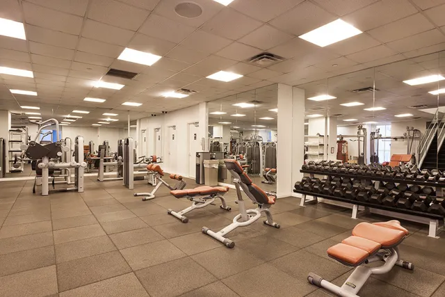 a room with gym equipment and a view of living room