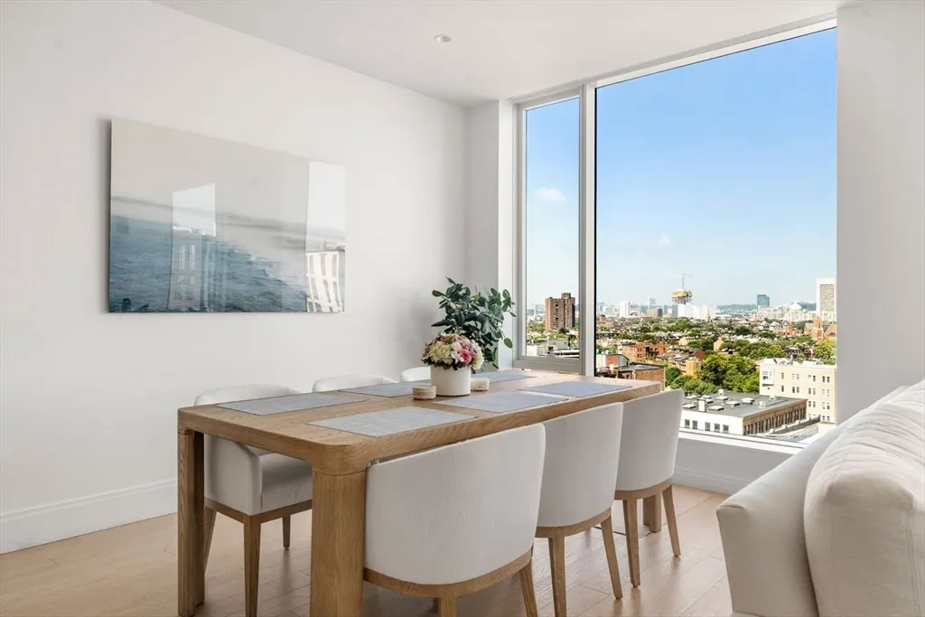 a dining room with furniture and wooden floor