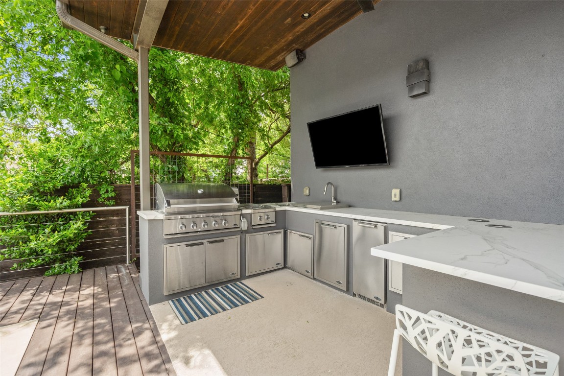 1207 East 13th Street Austin, TX 78702 - Photo 30 of 39 a room with a bed and a flat screen tv