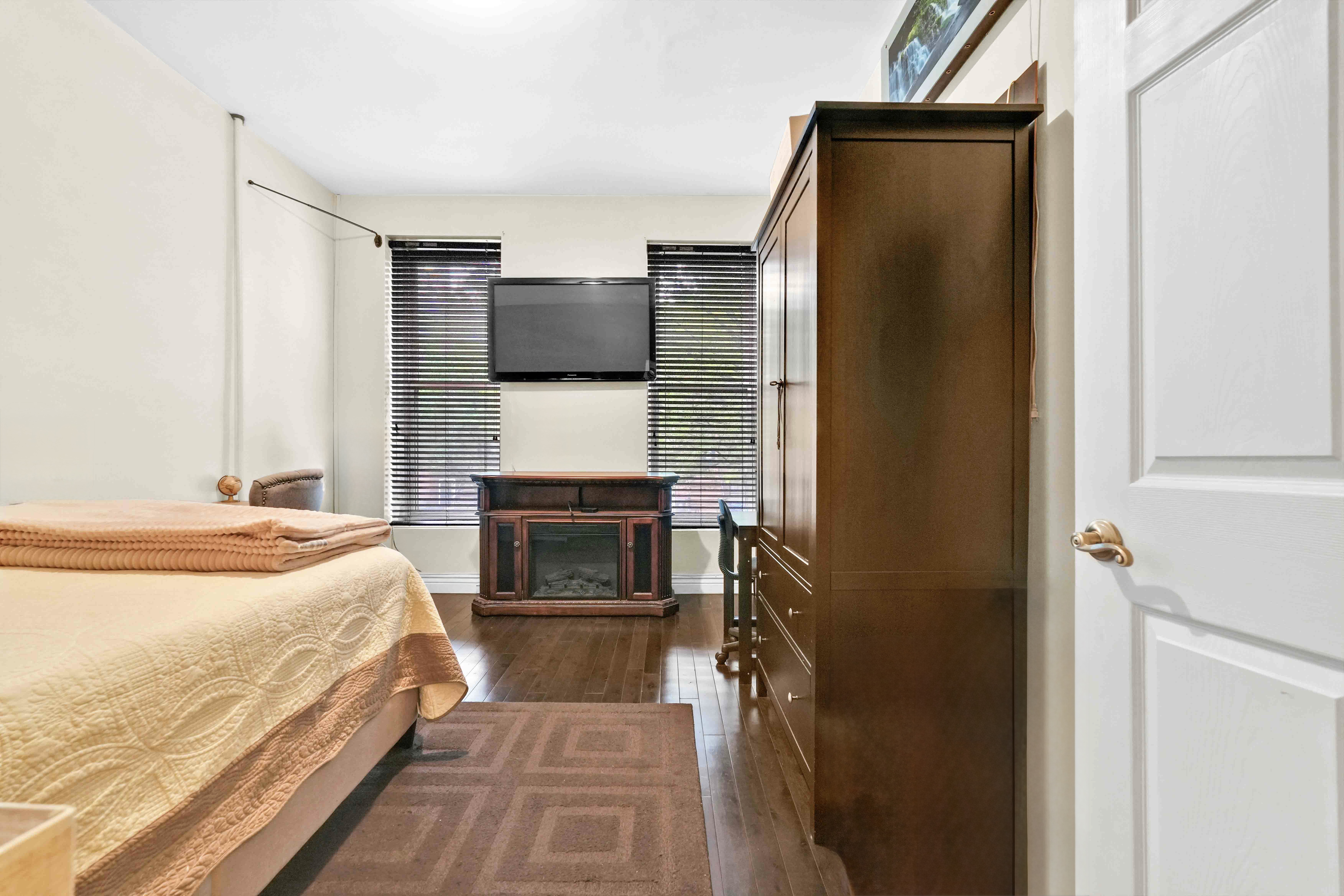 519 Monroe Street Brooklyn, NY 11221 - Photo 46 of 55 a spacious bedroom with a bed and a television