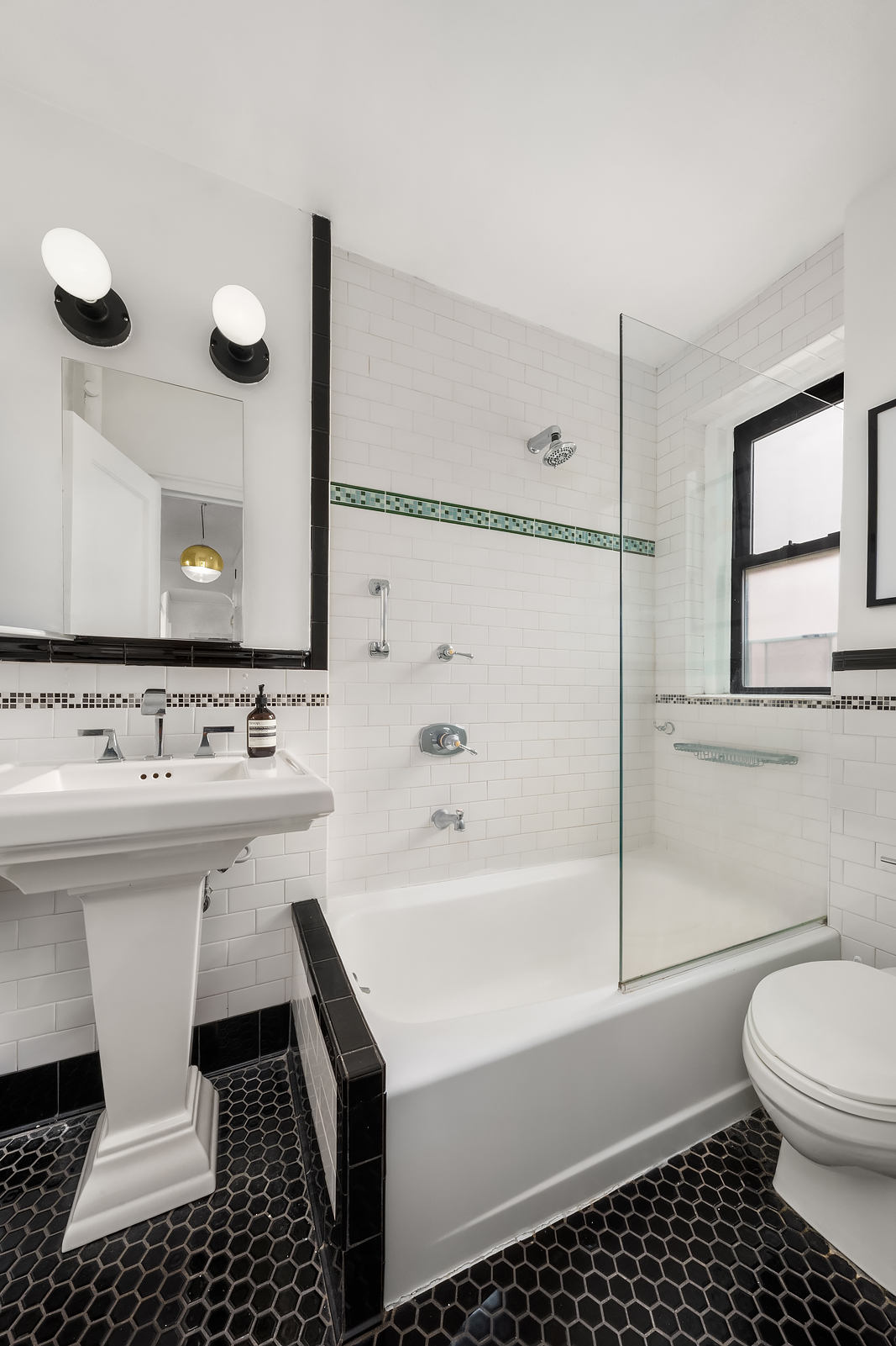 166 West 22nd Street, Unit 6C Manhattan, NY 10011 - Photo 5 of 11 a bathroom with a sink a toilet and a bathtub