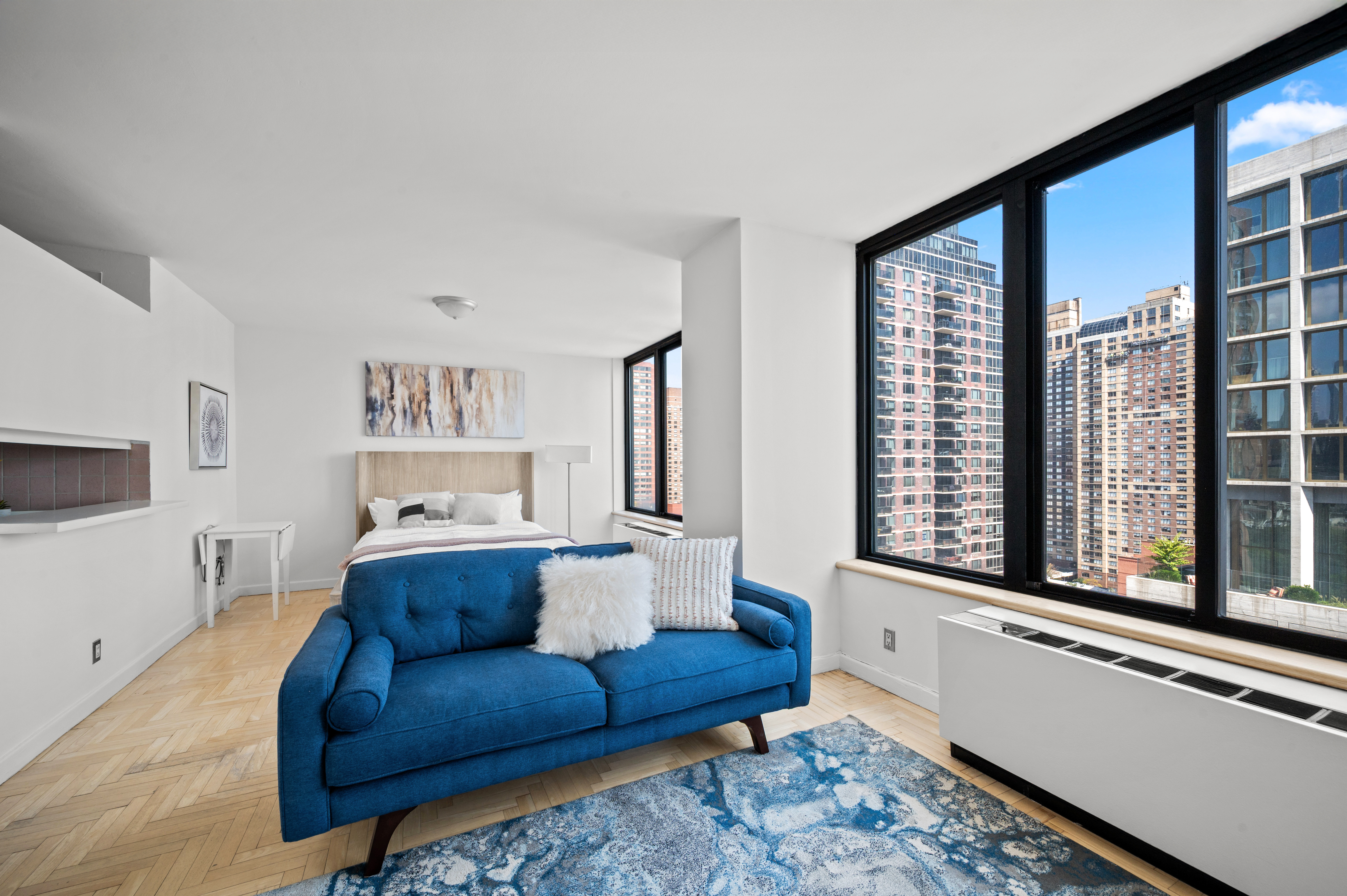 300 East 93rd Street, Unit 21C Manhattan, NY 10128 - Photo 3 of 6 a living room with furniture and a large window