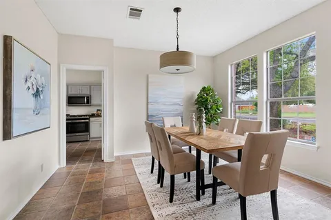 a dining room with furniture and window