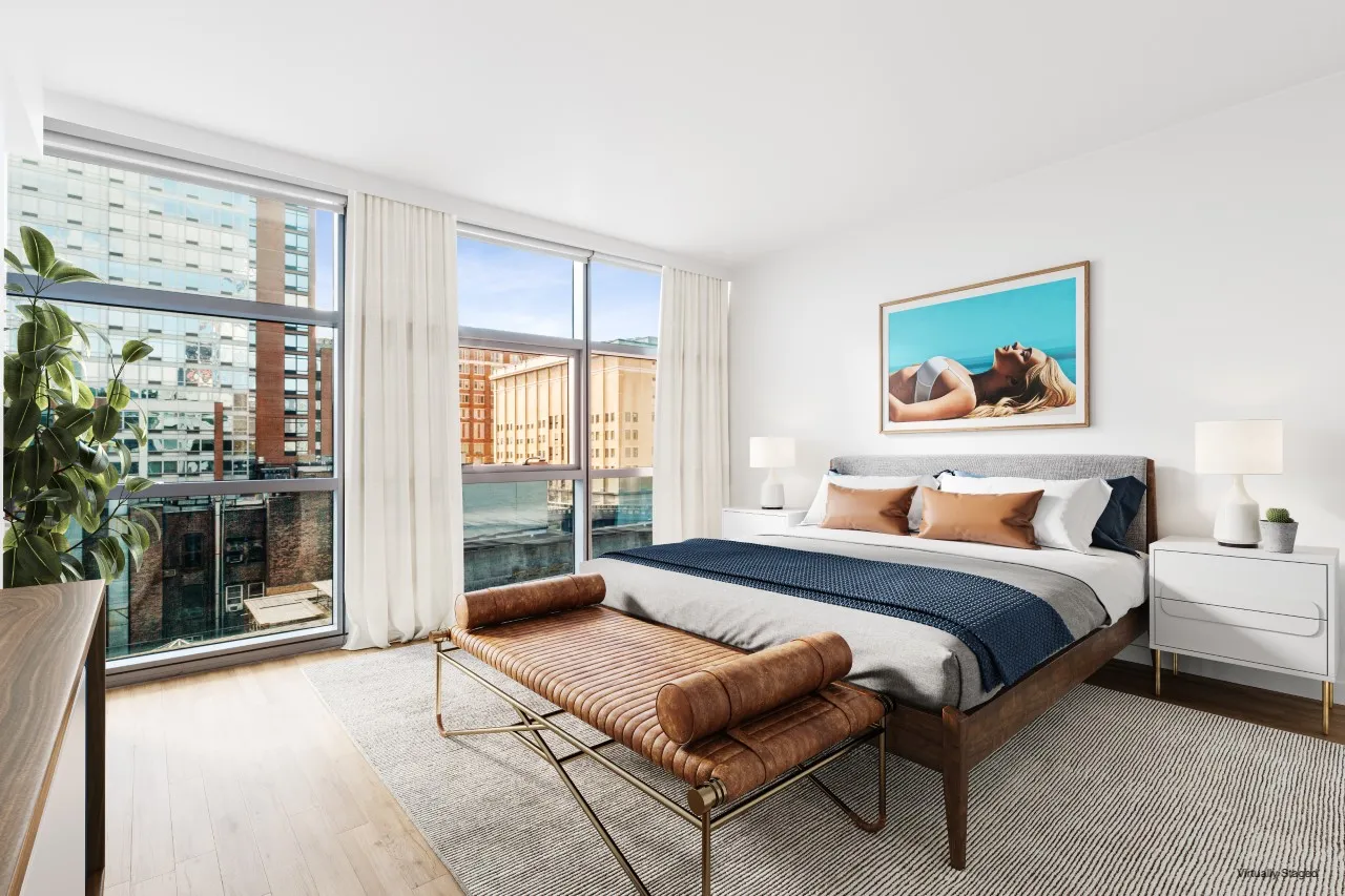 a spacious bedroom with a large bed and a large window