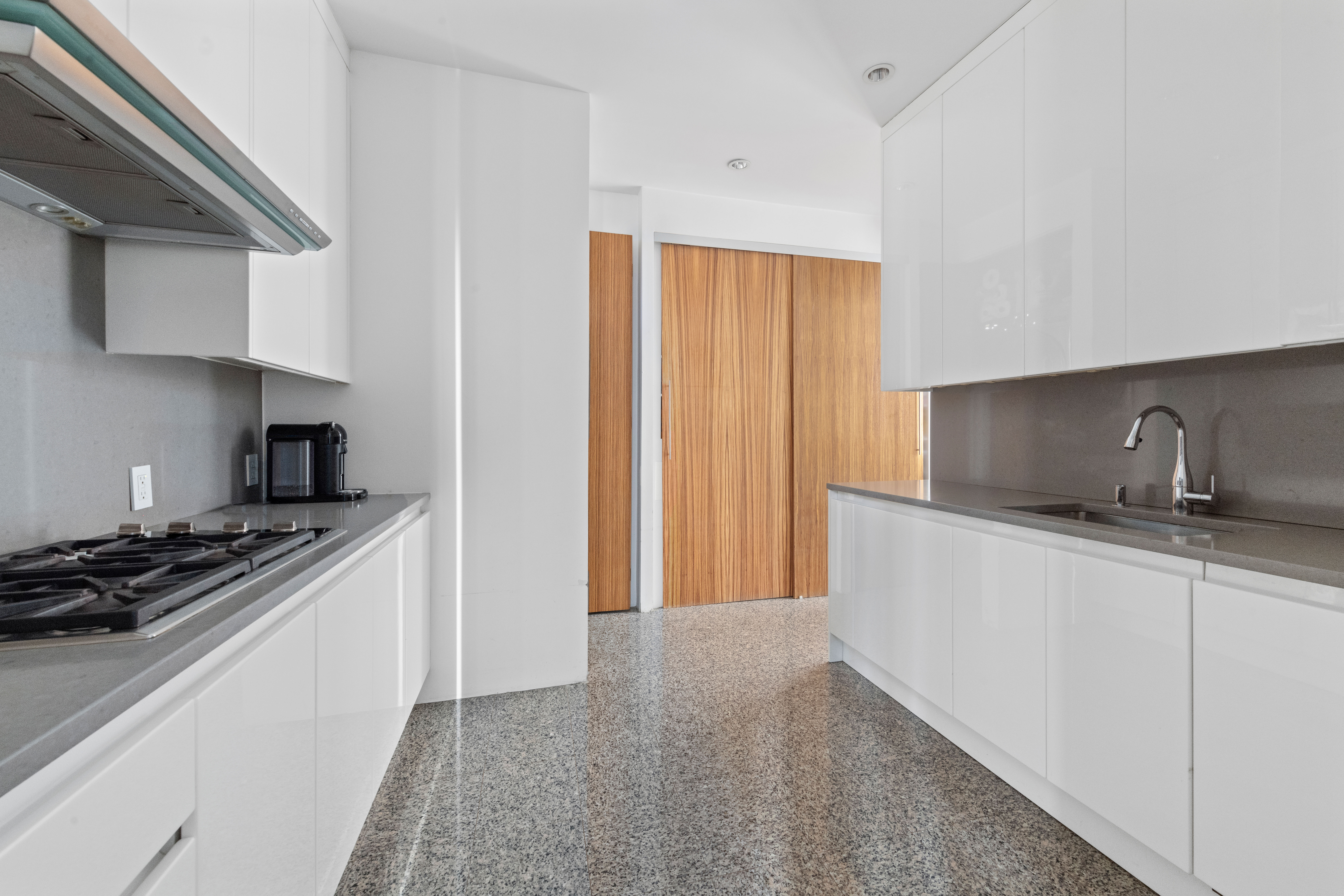 120 East 87th Street, Unit R16G Manhattan, NY 10128 - Photo 5 of 20 a kitchen with stainless steel appliances a sink stove and cabinets