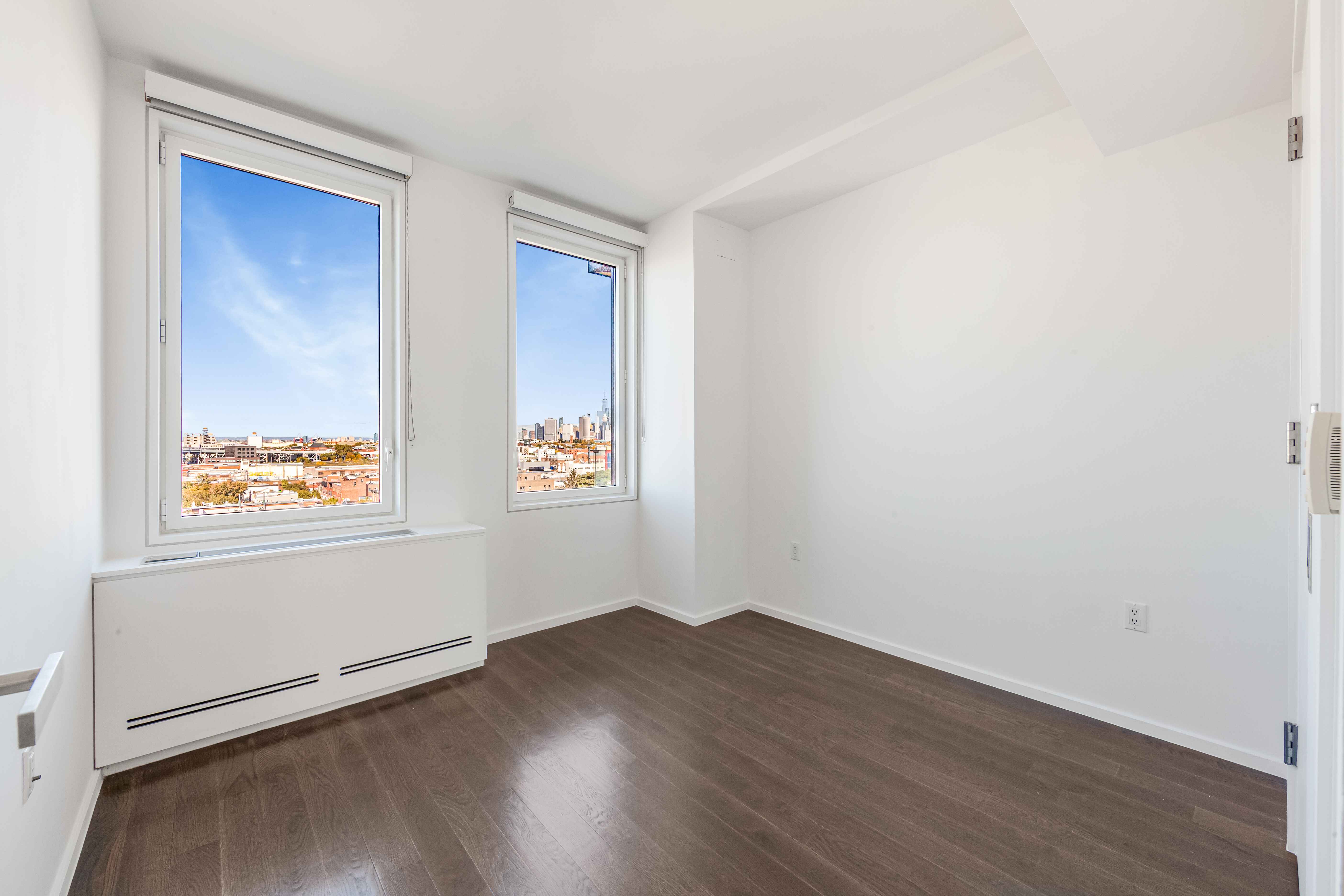 202 8th Street, Unit 8A Brooklyn, NY 11215 - Photo 11 of 21 an empty room with wooden floor and window