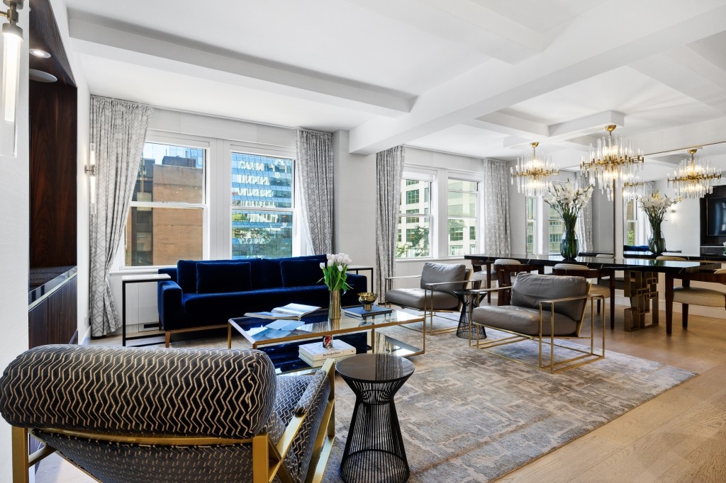 433 West 34th Street, Unit 4ABC Manhattan, NY 10001 - Photo 6 of 20 a living room with furniture a rug and a floor to ceiling window