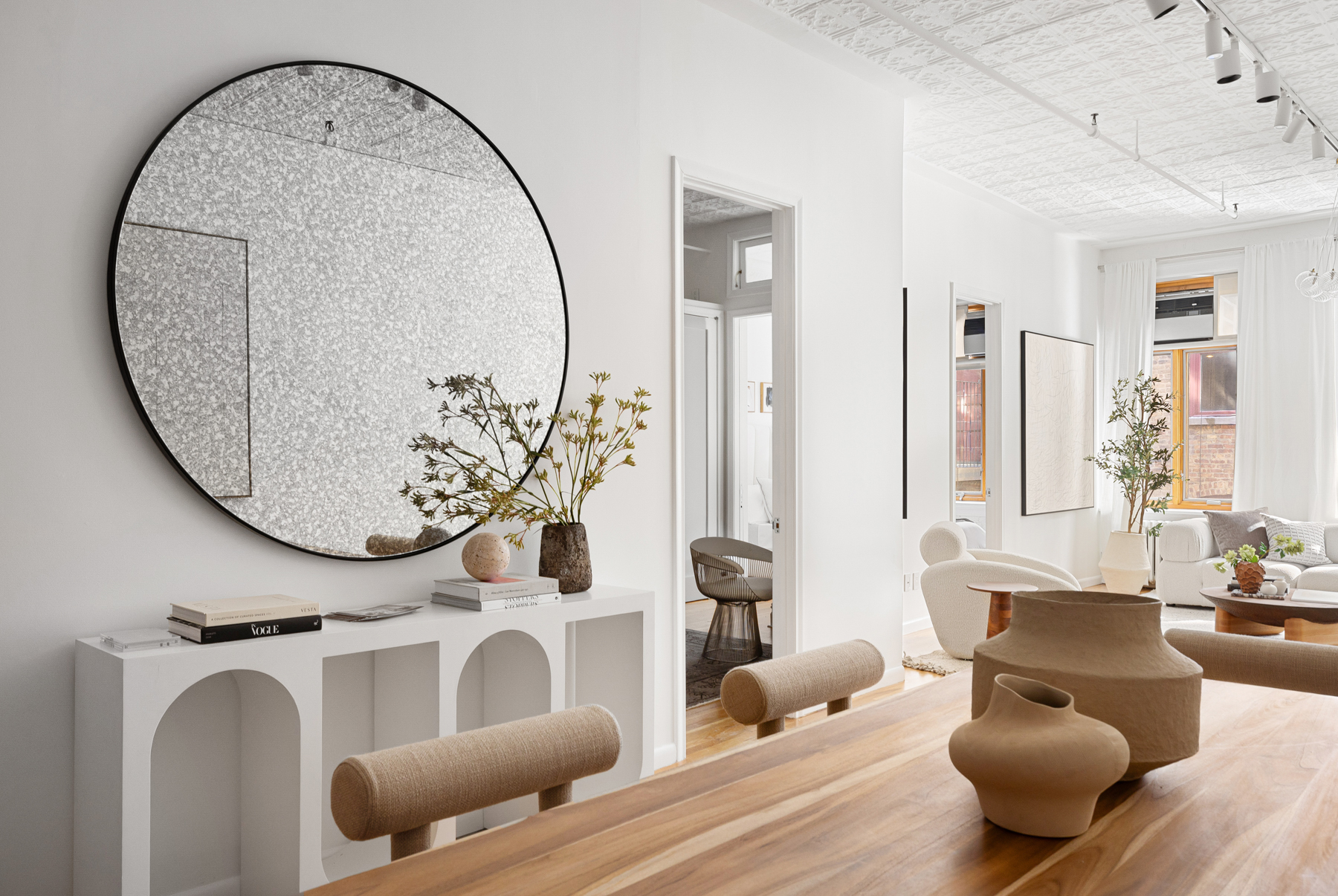 107 West 25th Street, Unit 5B Manhattan, NY 10001 - Photo 14 of 16 a living room with furniture and a mirror