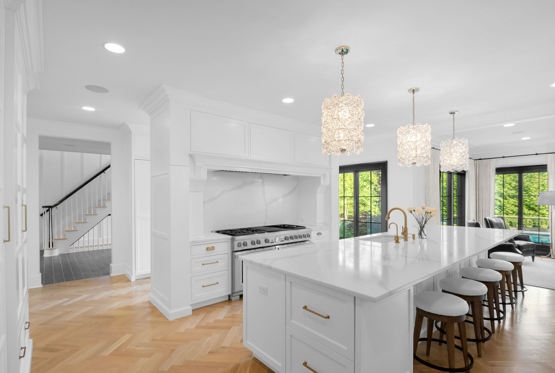 838 Seneca Road Franklin Lakes, NJ 07417 - Photo 24 of 92 an open kitchen with granite countertop a stove a sink a dining table and chairs with wooden floor