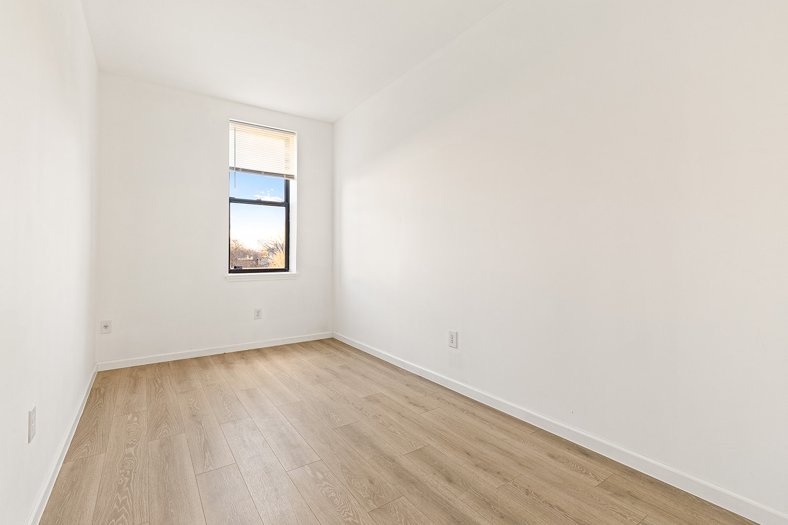 1644 Atlantic Avenue Brooklyn, NY 11213 - Photo 9 of 17 an empty room with wooden floor and windows