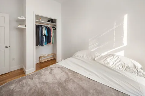 a bedroom with a bed and the view of bathroom