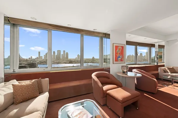 a living room with furniture and a floor to ceiling window