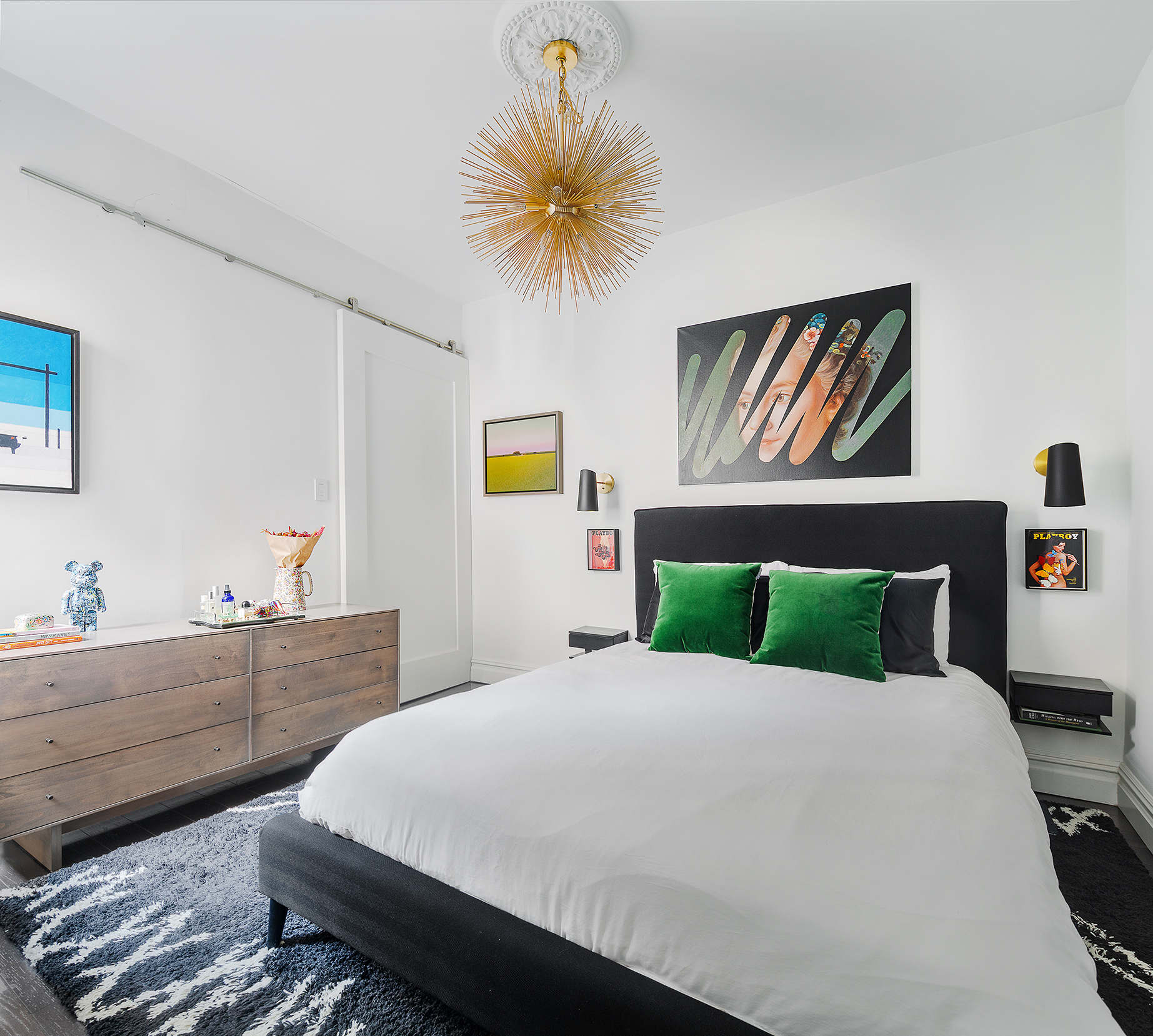 124 Thompson Street, Unit 24 Manhattan, NY 10012 - Photo 5 of 10 a bedroom with a bed and a painting on the wall