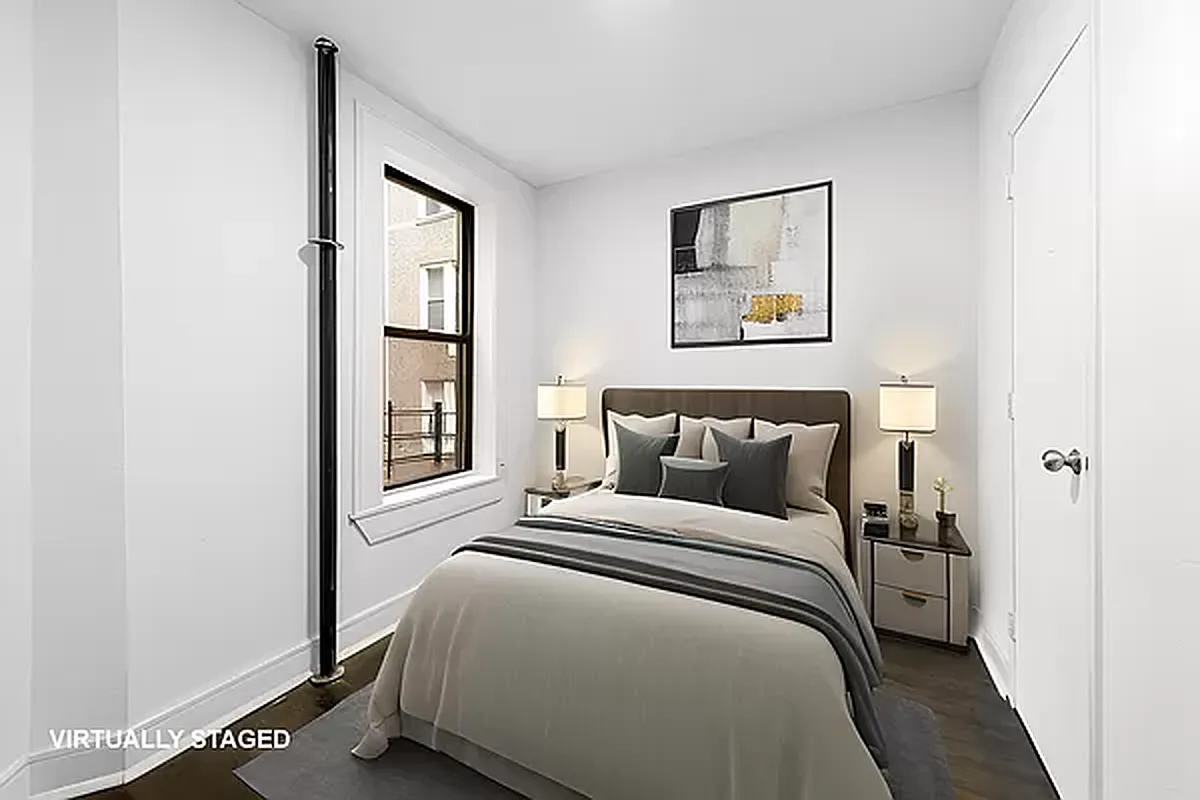 1392 Madison Avenue, Unit 15 Manhattan, NY 10128 - Photo 4 of 5 a bedroom with a bed and a window