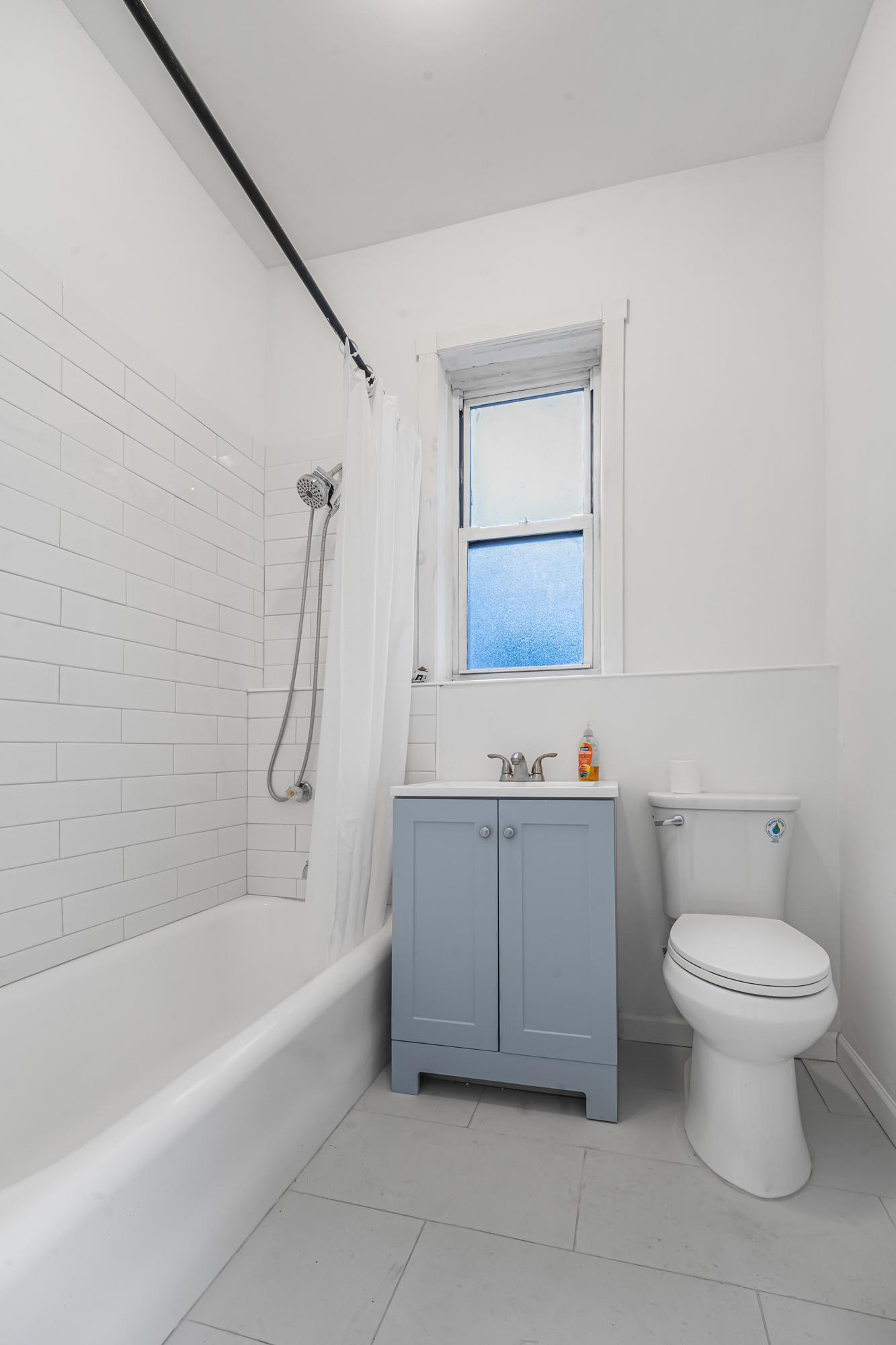 1384 Pacific Street, Unit A2 Brooklyn, NY 11216 - Photo 10 of 16 a bathroom with a sink a toilet and bathtub