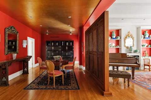a dining room with furniture and wooden floor