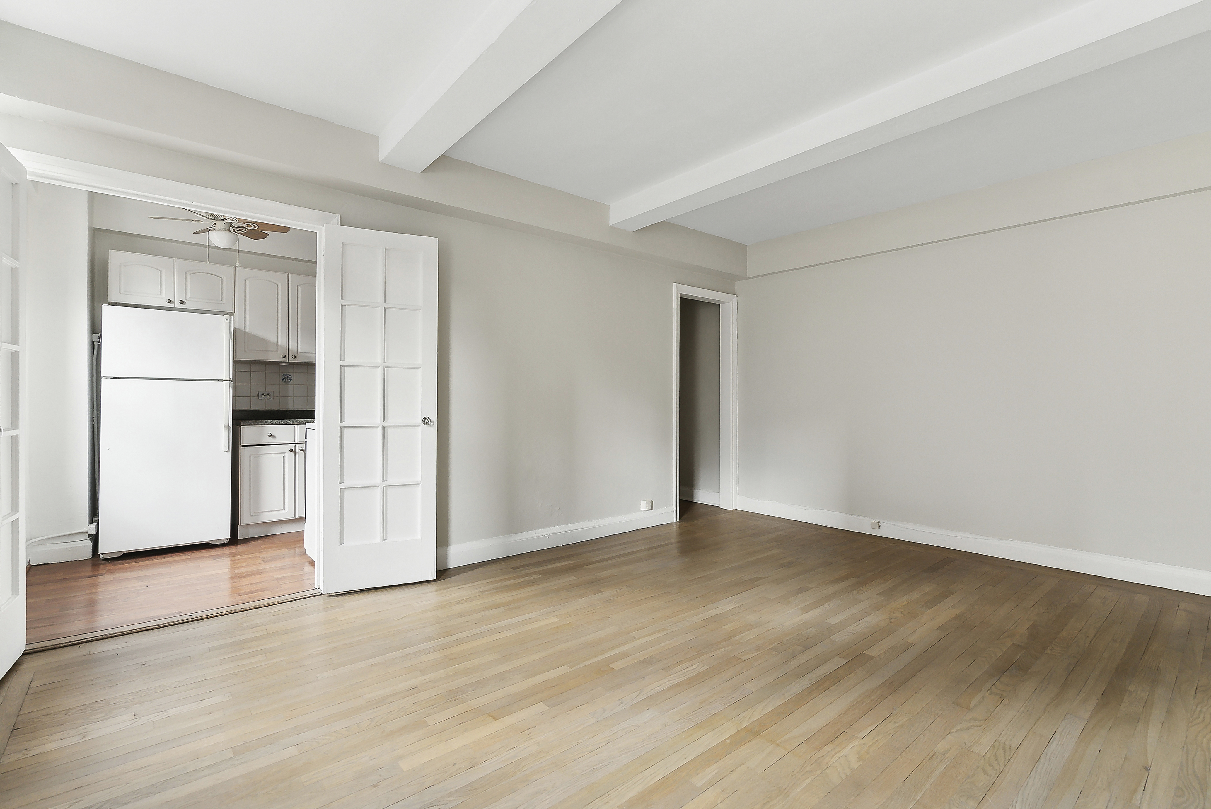 321 East 54th Street, Unit 9B Manhattan, NY 10022 - Photo 4 of 13 a view of an empty room with wooden floor