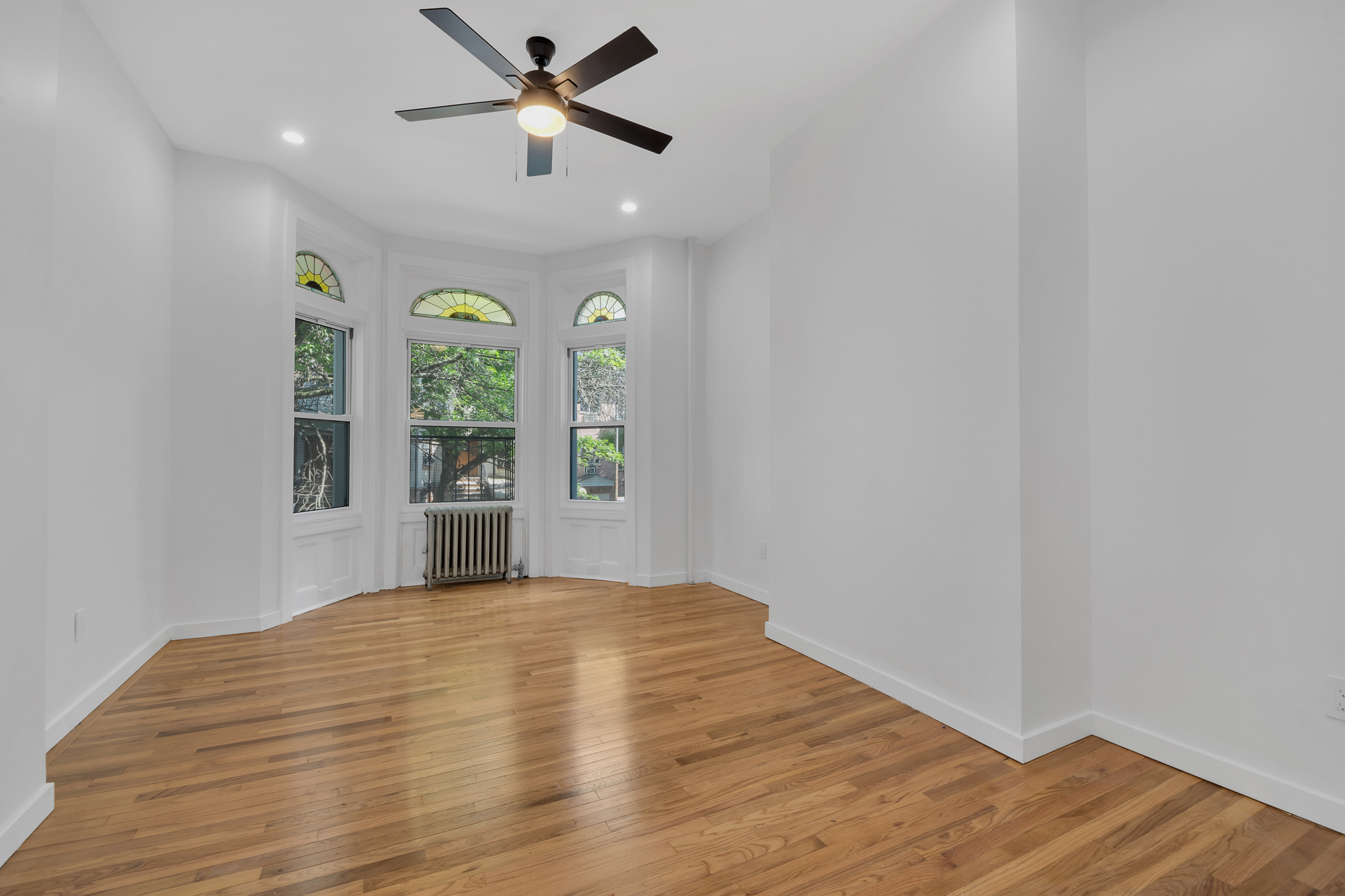 1275 Jefferson Avenue, Unit 2 Brooklyn, NY 11221 - Photo 6 of 11 a view of empty room with wooden floor and fan