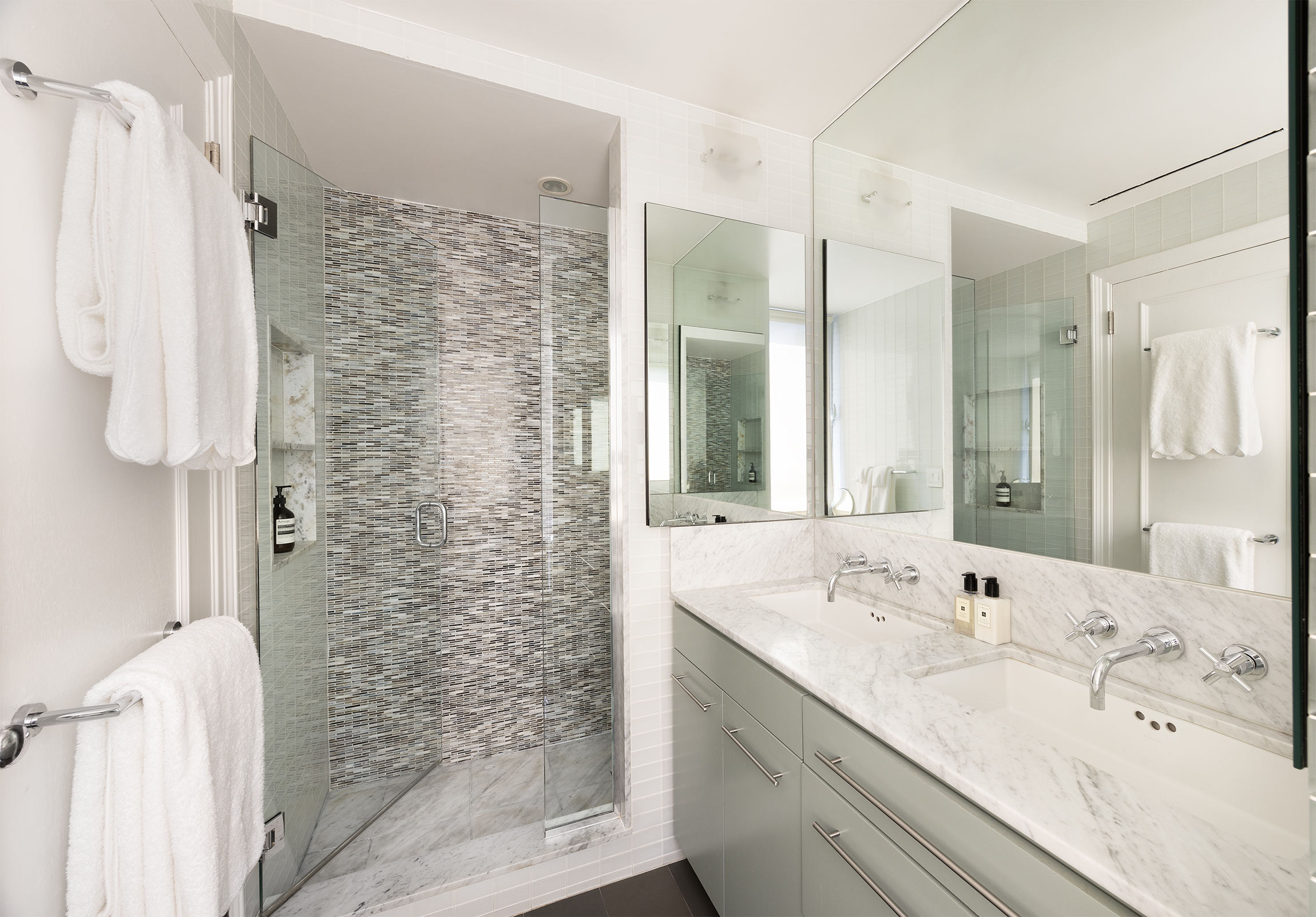 49 East 86th Street, Unit 11A Manhattan, NY 10028 - Photo 6 of 10 a bathroom with a double vanity sink mirror and shower