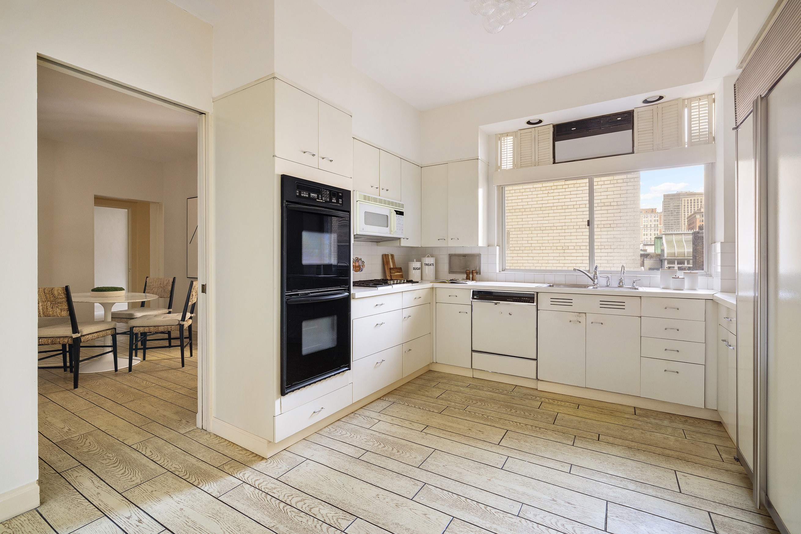 1120 5th Avenue, Unit 7B Manhattan, NY 10128 - Photo 13 of 17 a kitchen with white cabinets and appliances