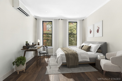106 Bedford Avenue, Unit 3L Brooklyn, NY 11249 - Photo 3 of 7 a bedroom with furniture and a large window