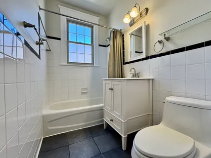 a bathroom with a toilet a sink and bathtub