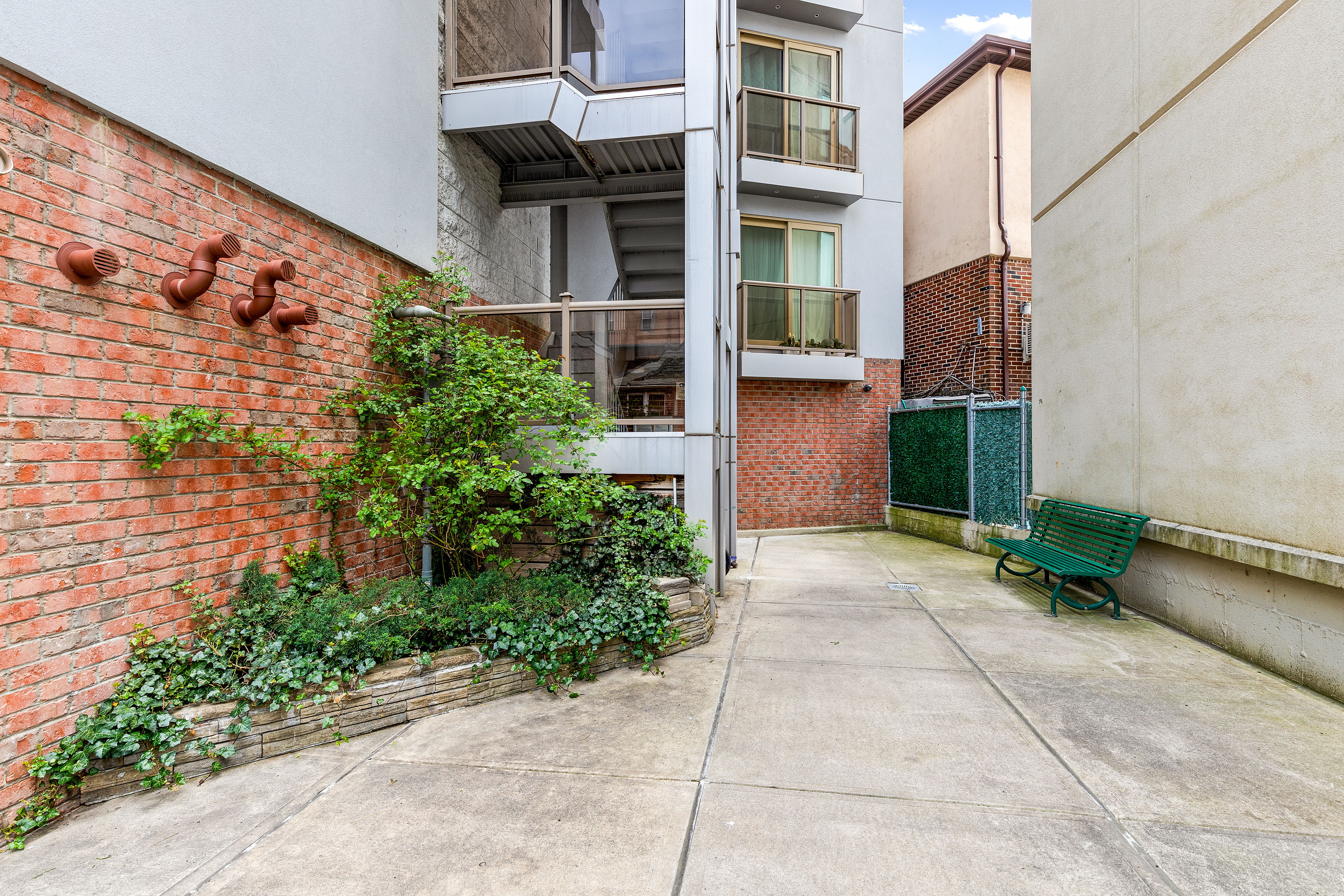 62 Brighton 2nd Place, Unit 4B Brooklyn, NY 11235 - Photo 11 of 12 a backyard of a house with potted plants