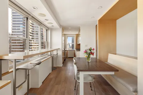 a large kitchen with kitchen island a large window